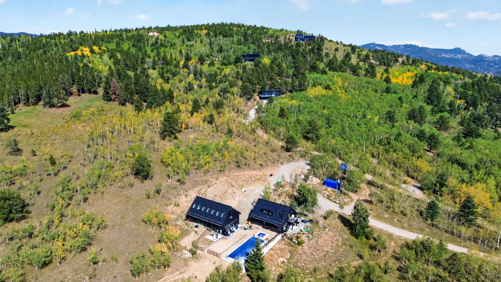 Mountain Cabins Among Golden Aspens.png