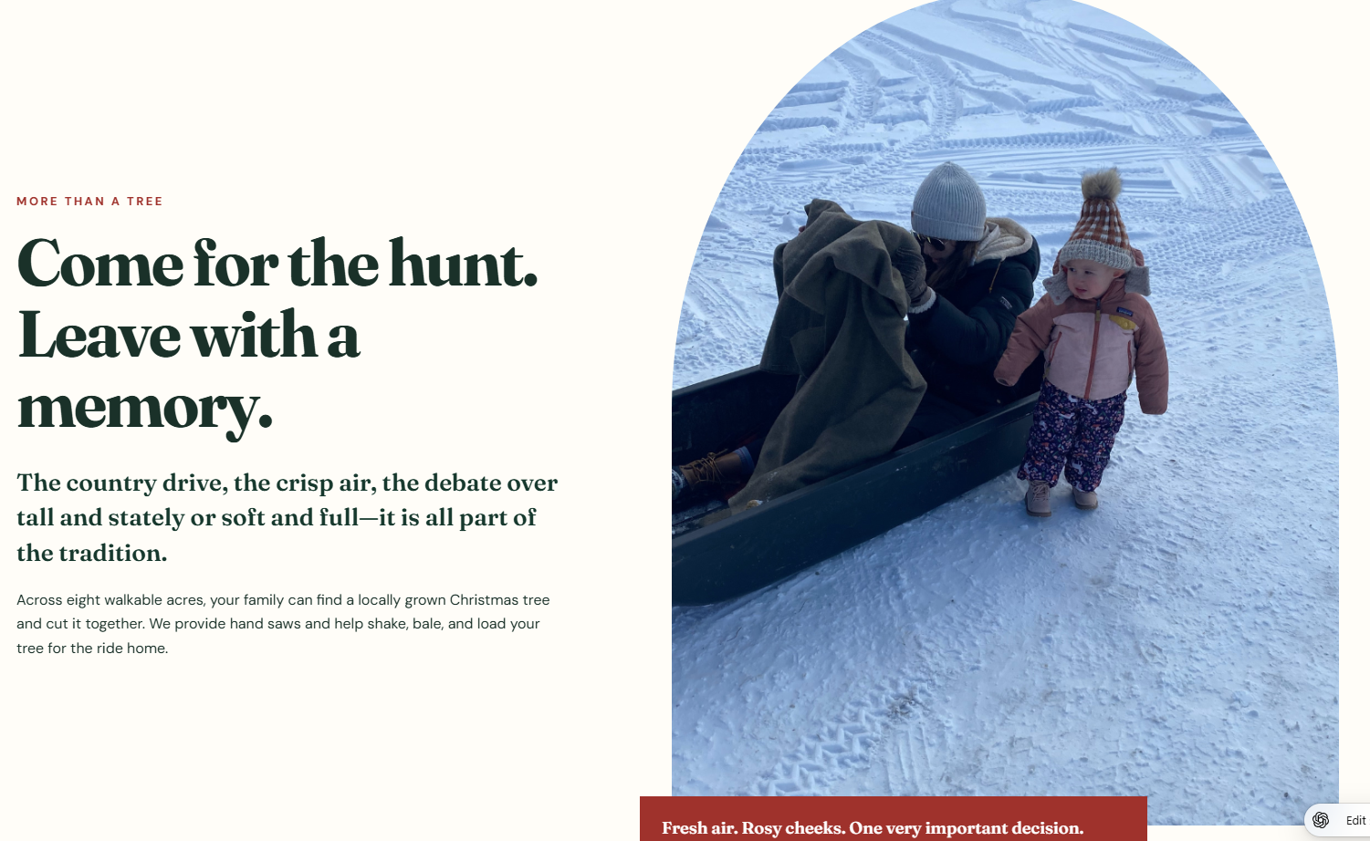 A person in a navy coat and white knit hat sitting inside a sled, pulling a young girl in a pink jacket and floral pants, walking on snow-covered ground during winter, with another person partially visible in the sled.