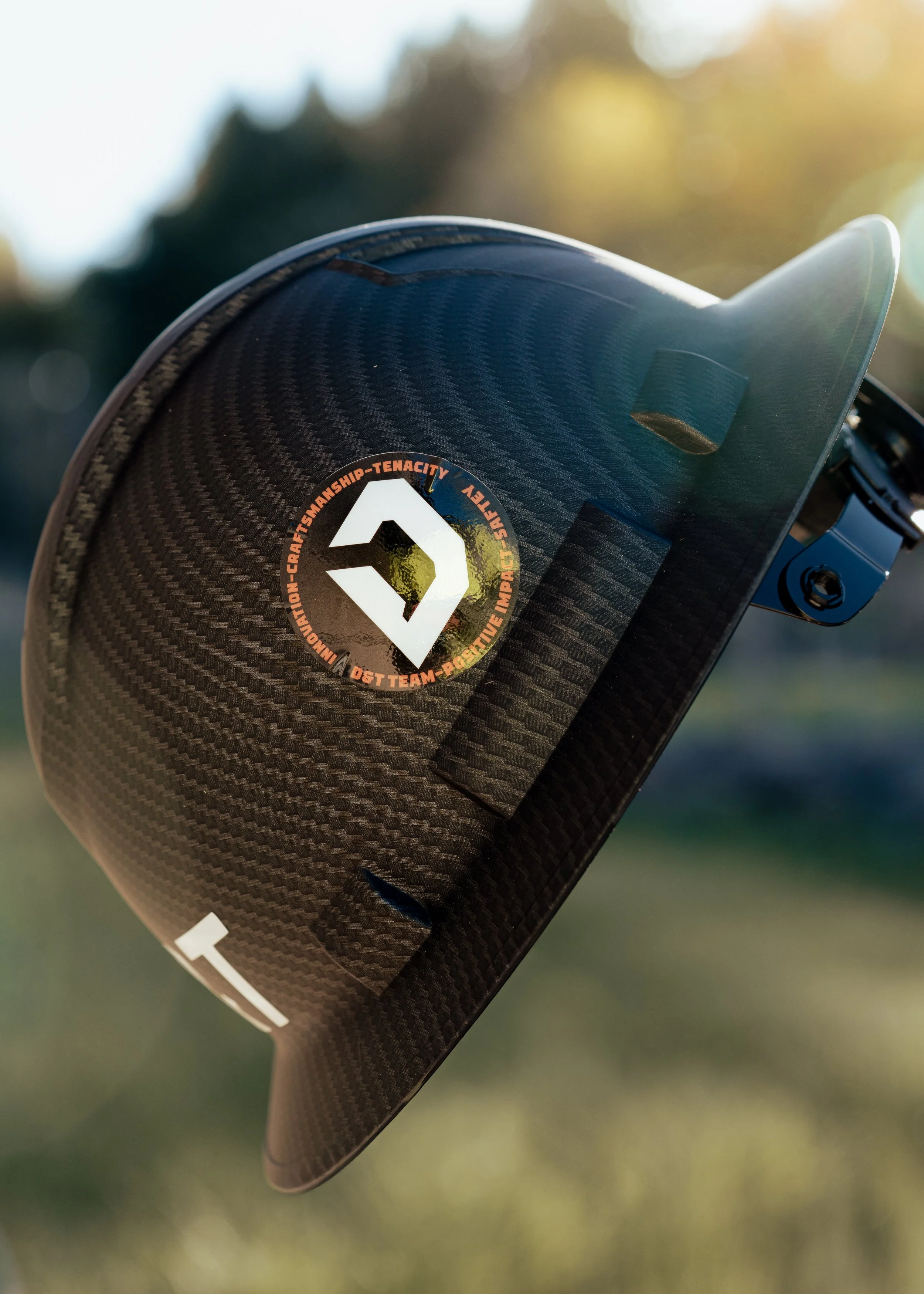 Close-up of our D&T Excavation hard hat in Oregon, with a blurred background at one of our current site developments in Portland, OR.
