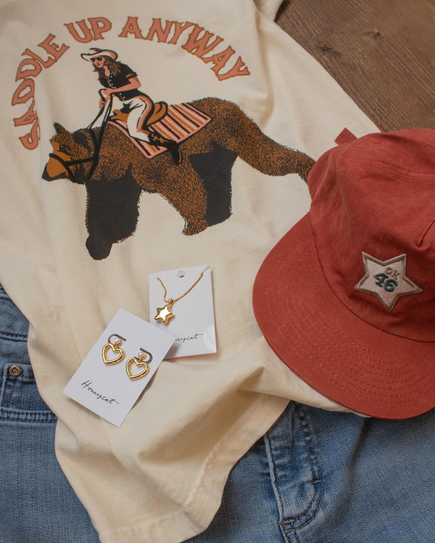 Sunshine today has us feeling like a weekend. 🌞🍉🐻 Couple new tees hanging around the shop. We paired them with some chunky vintage inspired earrings from @clubhouse.goods and our stash of thrifted vintage denim! You can find all of that on shelves