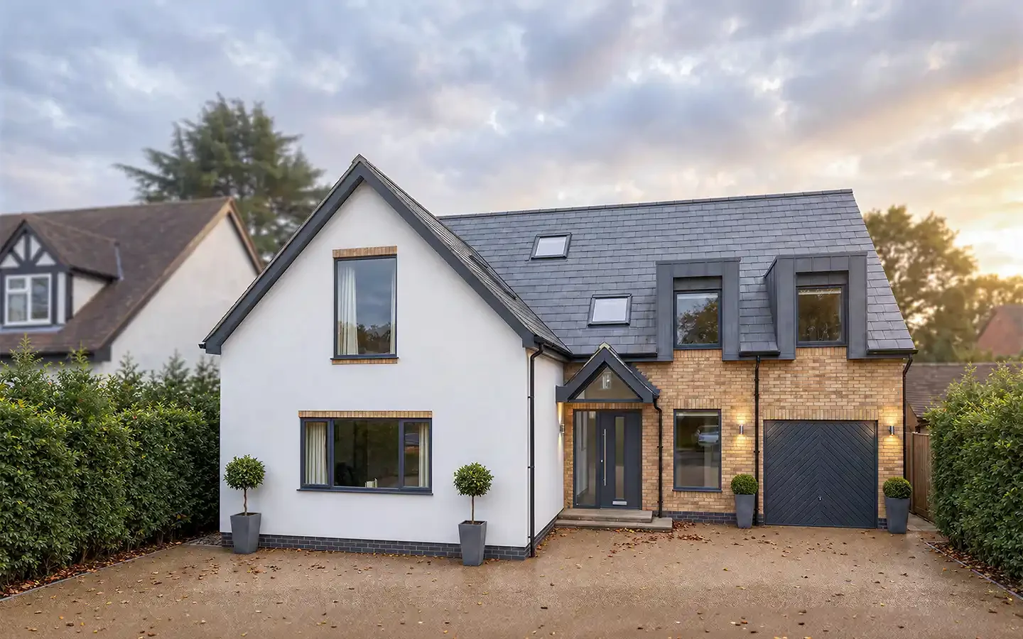 Front view of a remodelled home in Balsall Common, showing the raised main roof with dormer windows, a front extension, new entrance porch and additional accommodation above the garage.