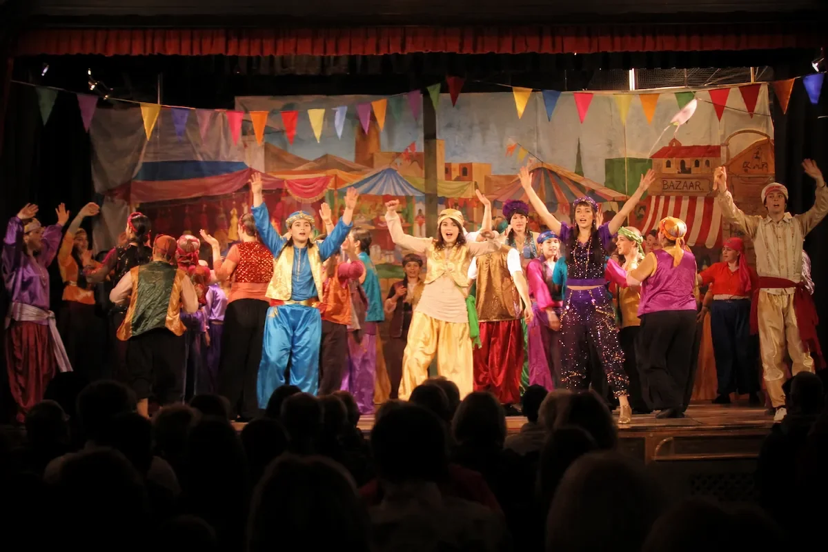 A bight market scene in Aladdin pantomime script performance
