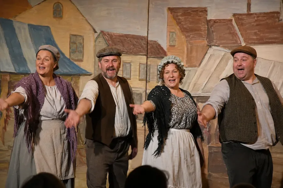 Ensemble as townsfolk in a production of Beauty and the Beast