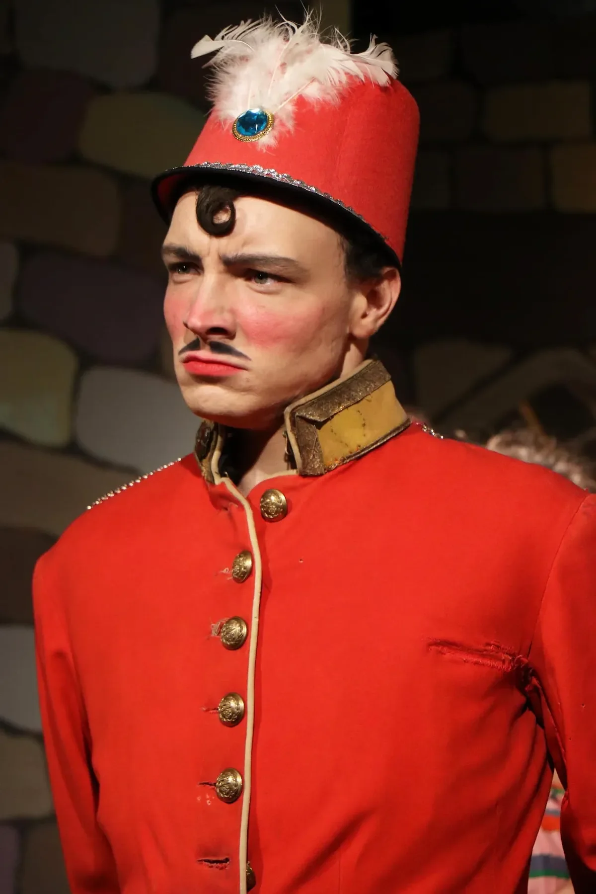 Flummox wearing a bright red hat and jacket