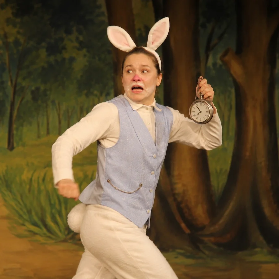 The white rabbit running across the stage in a production of Alice In Wonderland