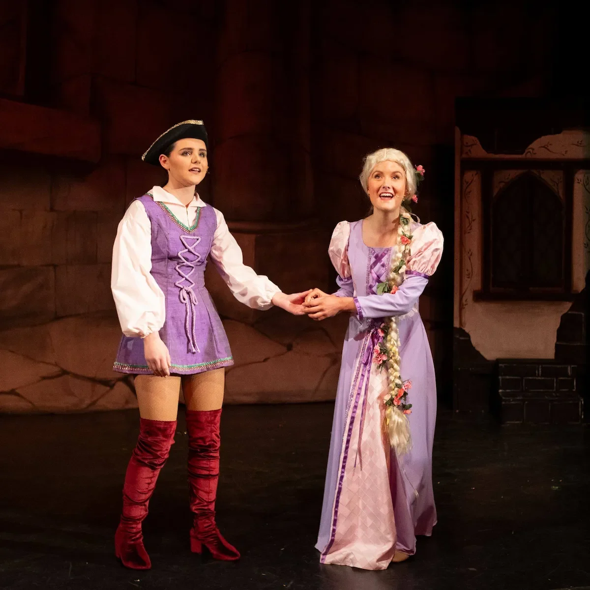 Two performers in a production of Rapunzel pantomime script