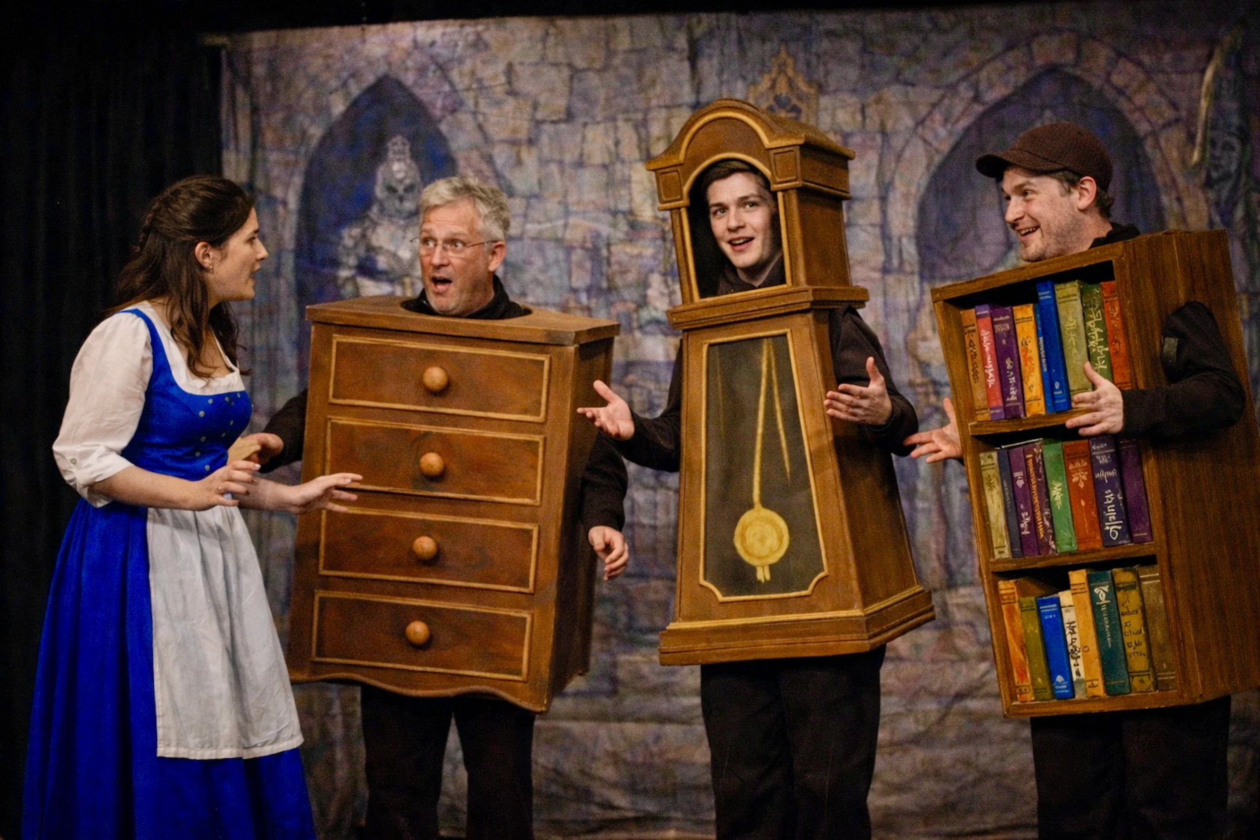 Beauty speaking with the talking furniture in the castle in Beauty and the Beast pantomime script performance