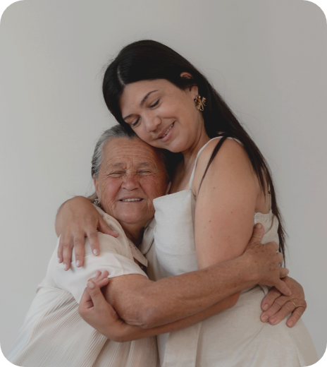 Therapy in Kitchener, Young woman and elderly woman hugging and smiling.