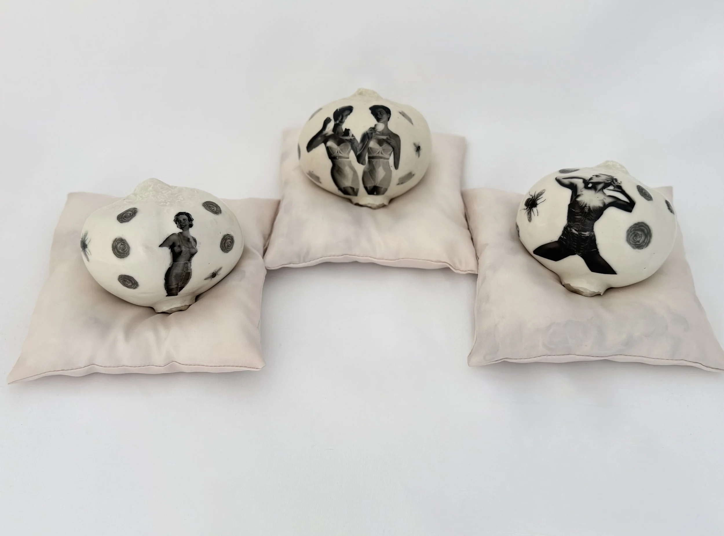 Porcelain with water slide decals on satin and down pillows, 2026, 6x6x6 inches 