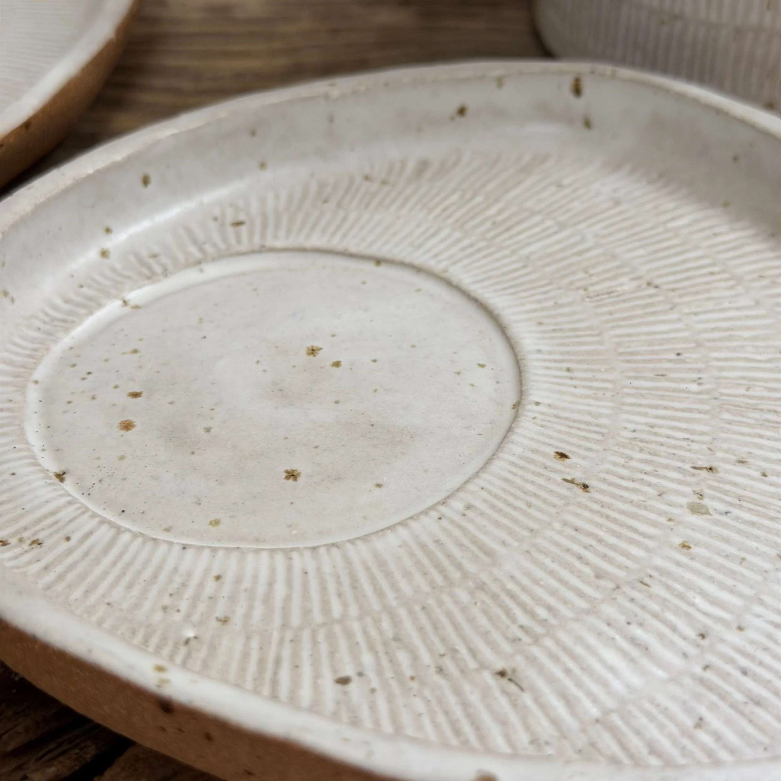 handcrafted cup and saucer, made from speckled stoneware clay and finished in a satin white glaze