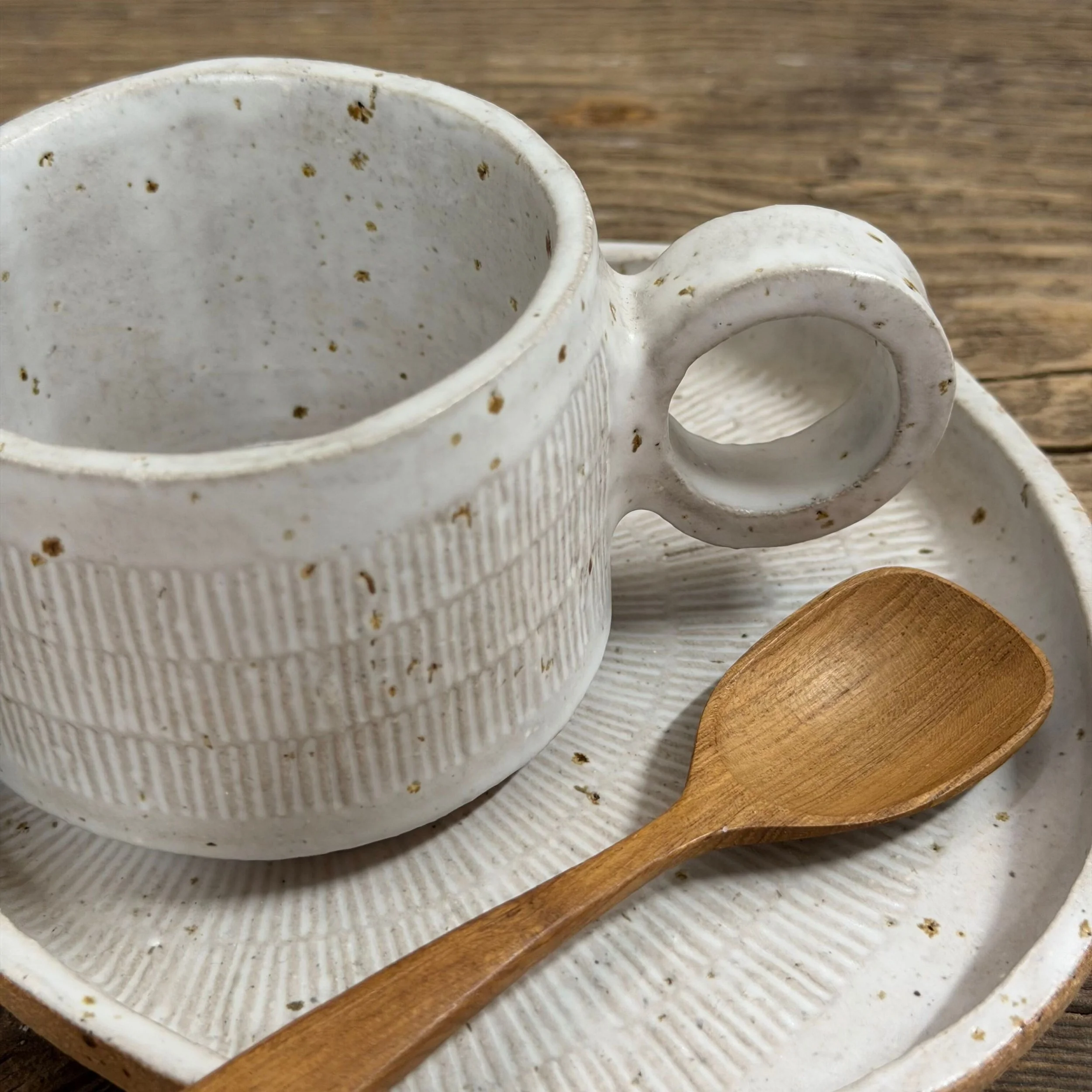 handcrafted cup and saucer, made from speckled stoneware clay and finished in a satin white glaze