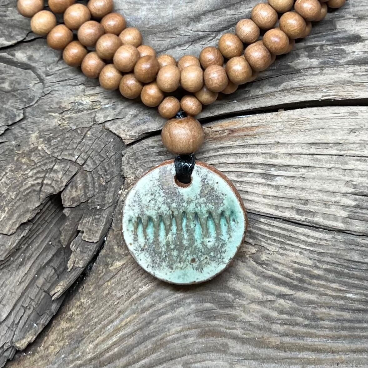 Round ceramic pendant with green glaze and sandalwood bead necklace