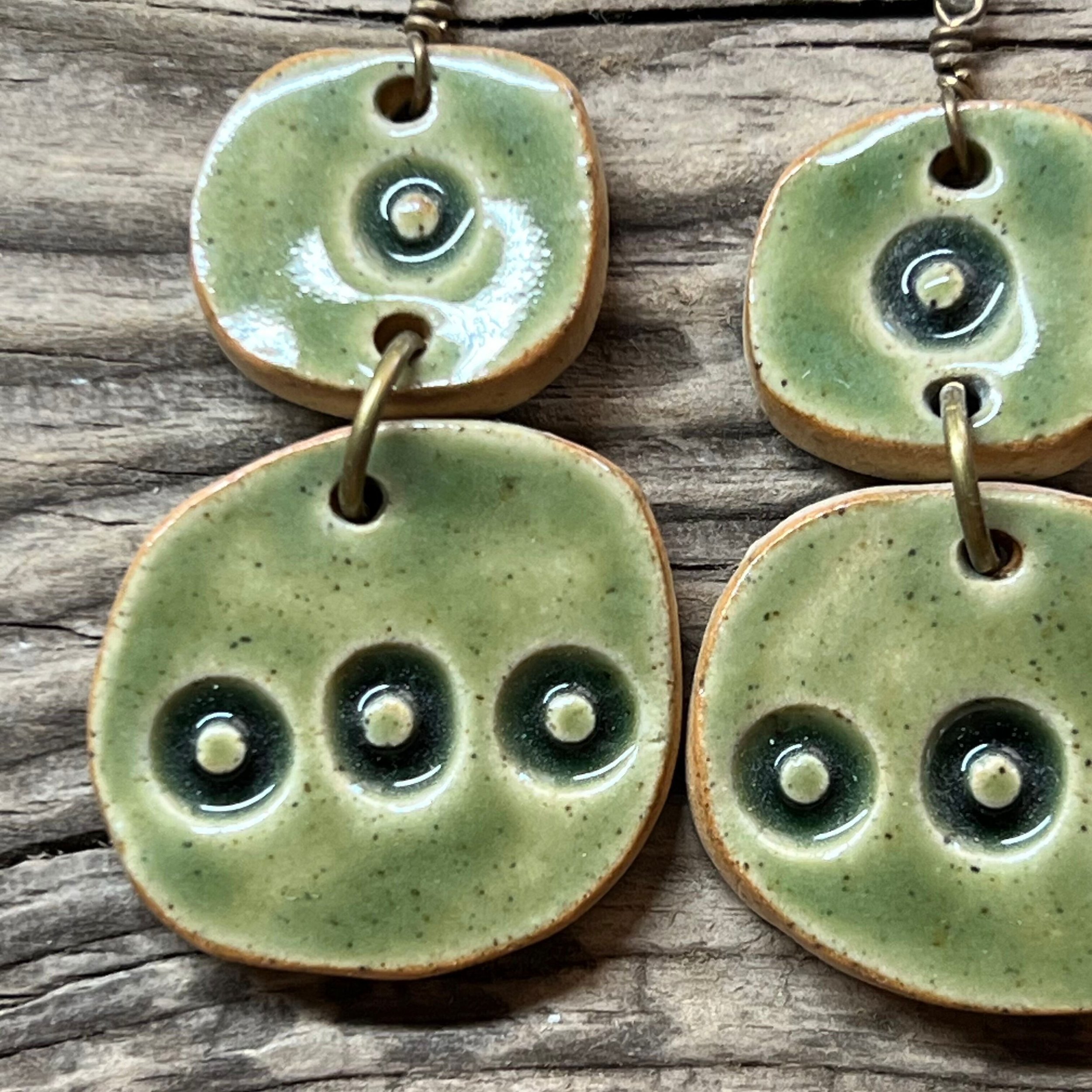 Earrings handcrafted from stoneware clay and finished with a transparent green glaze
