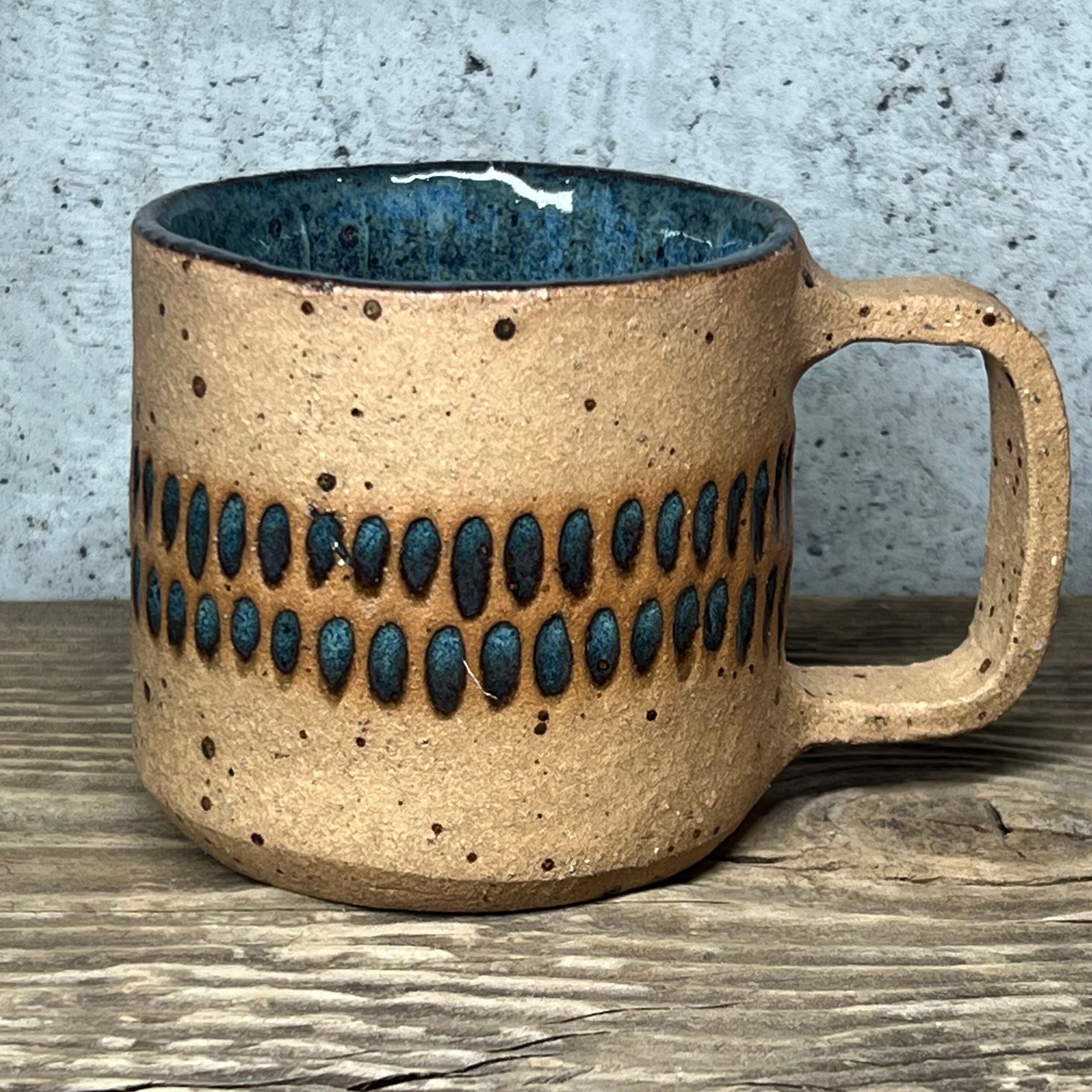 handcrafted cup, made from speckled stoneware clay, finished in a beautiful blue glaze
