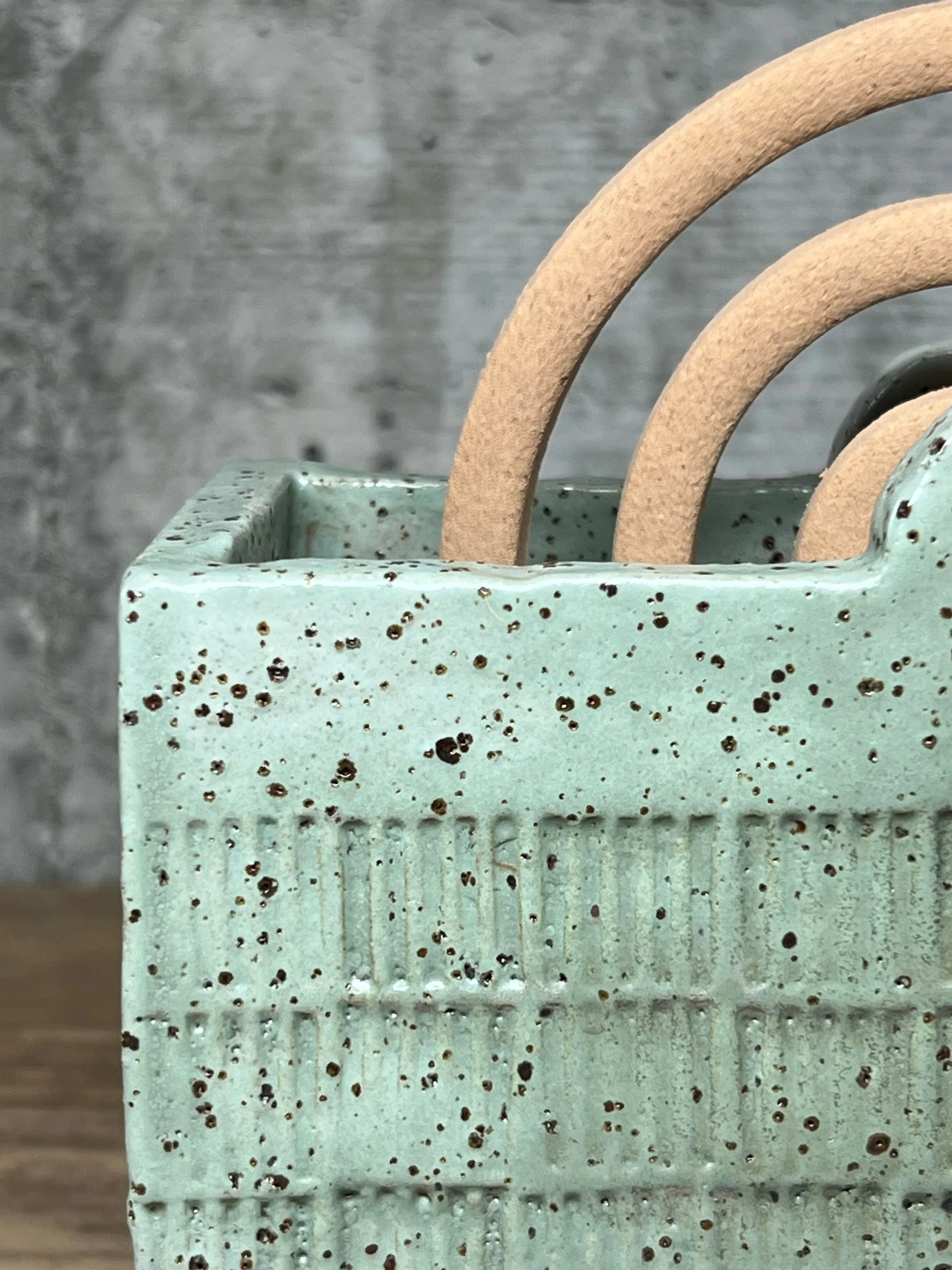 handcrafted mozzie coil holder, made from durable stoneware clay and finished in a mint glaze