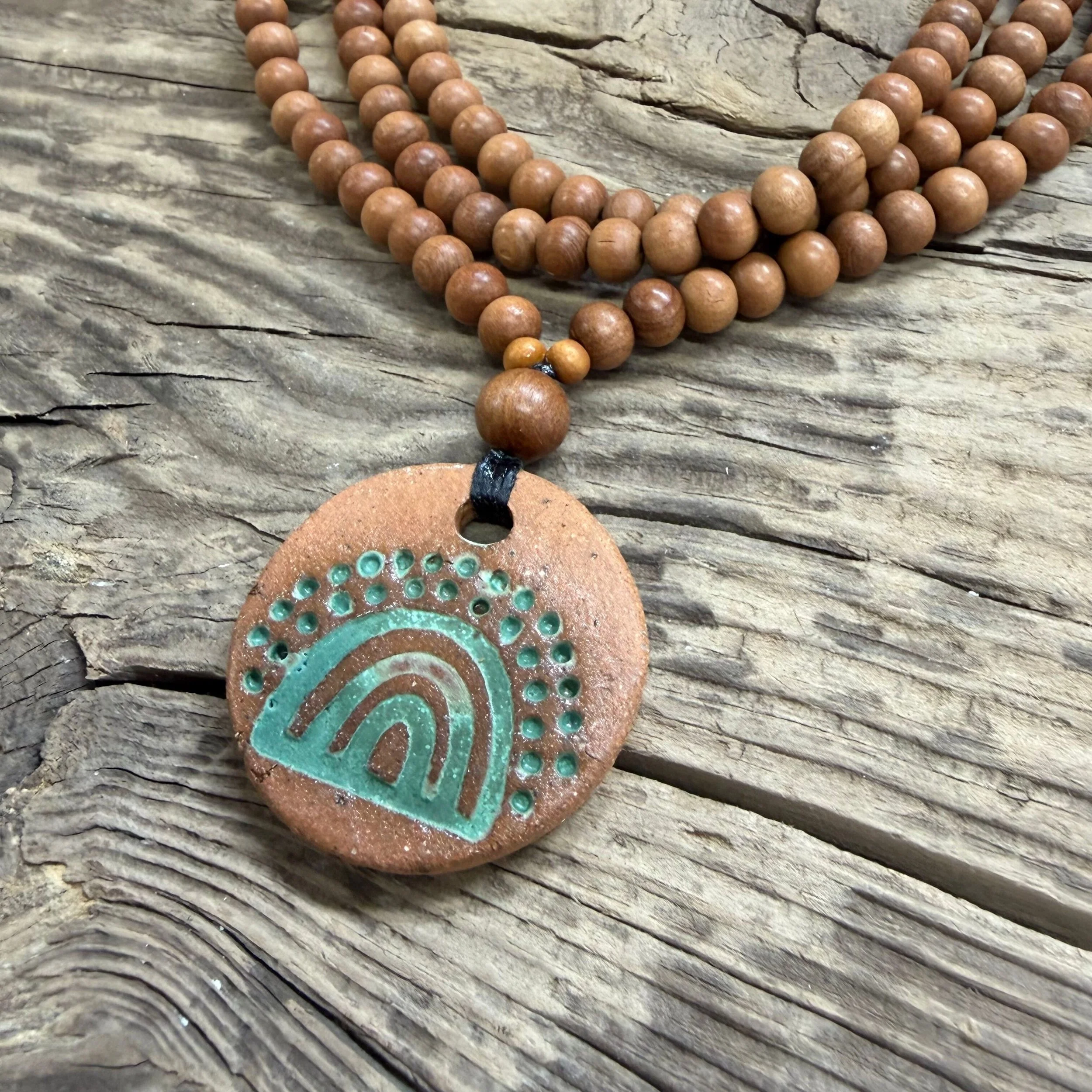 Round ceramic pendant with green glaze and sandalwood bead necklace