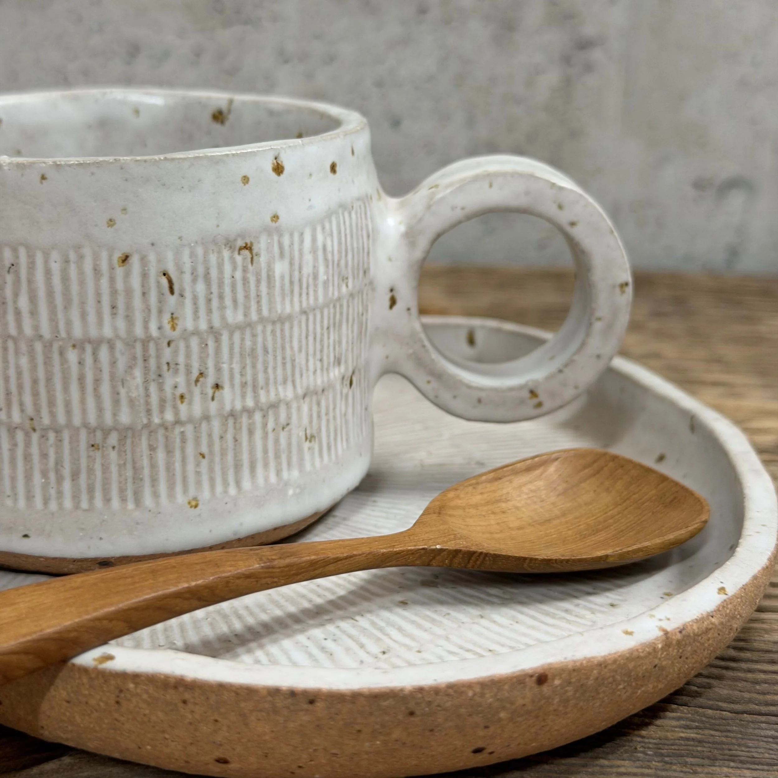 handcrafted cup and saucer, made from speckled stoneware clay and finished in a satin white glaze