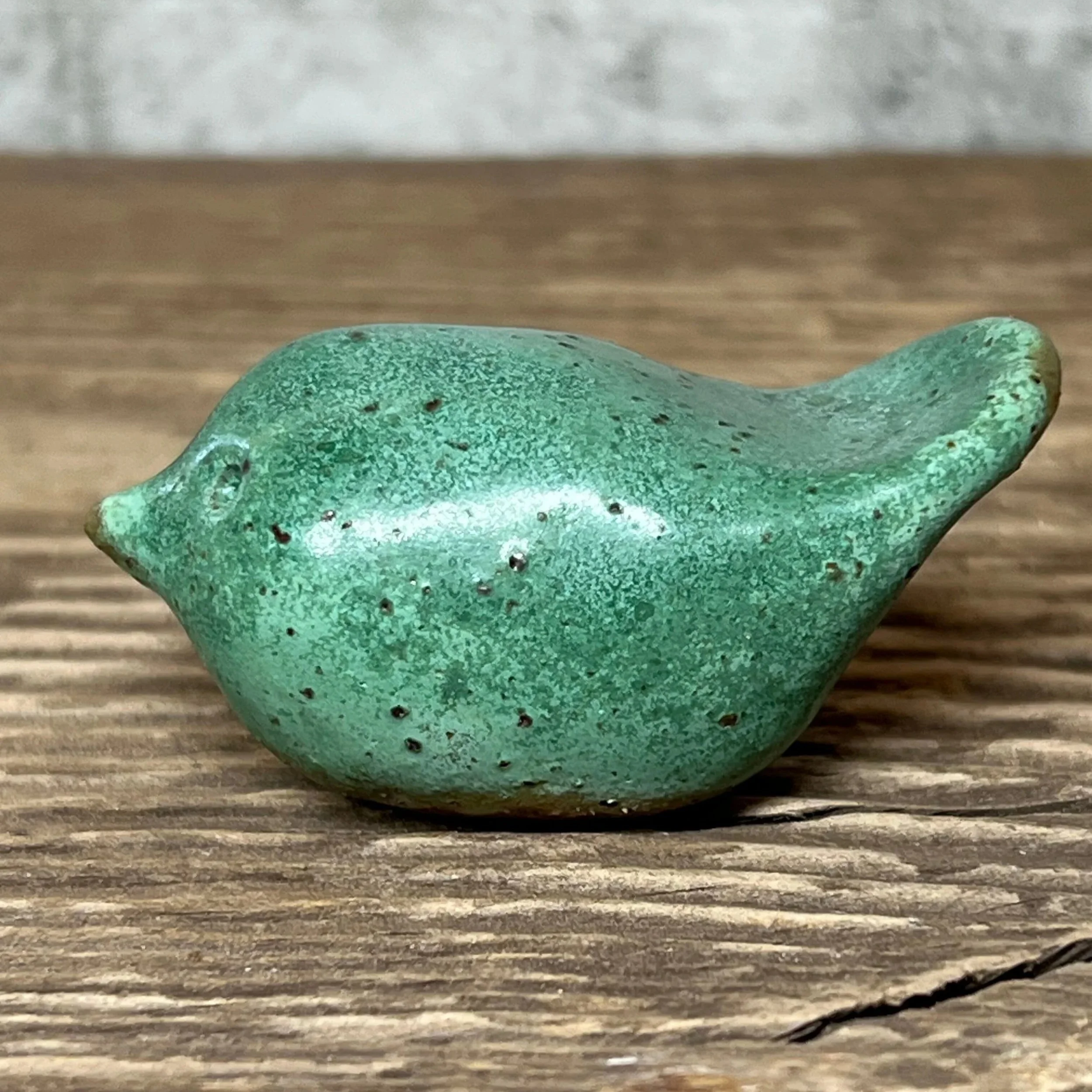 Ceramic bird handcrafted from stoneware clay and finished in a green glaze,
