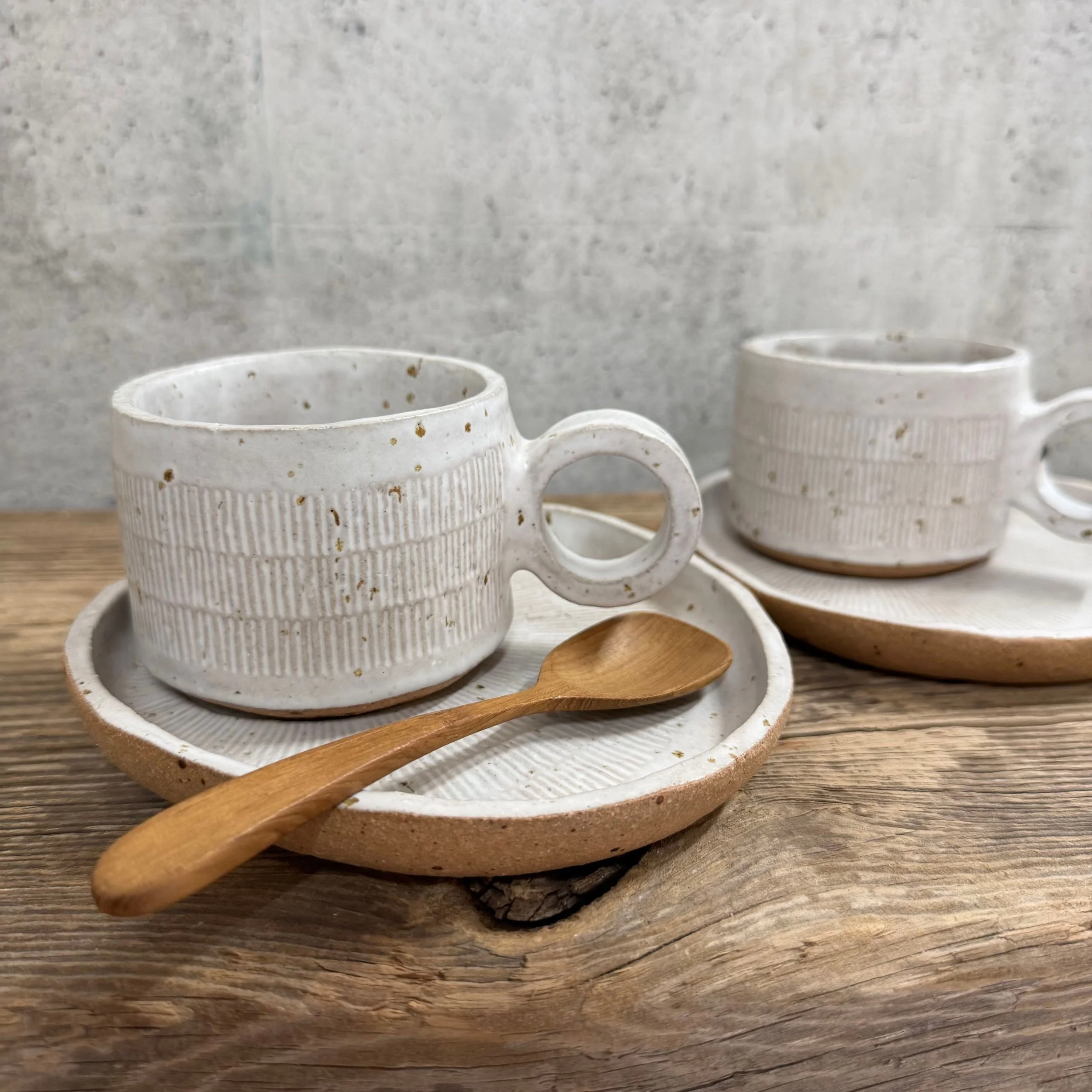 handcrafted cup and saucer, made from speckled stoneware clay and finished in a satin white glaze