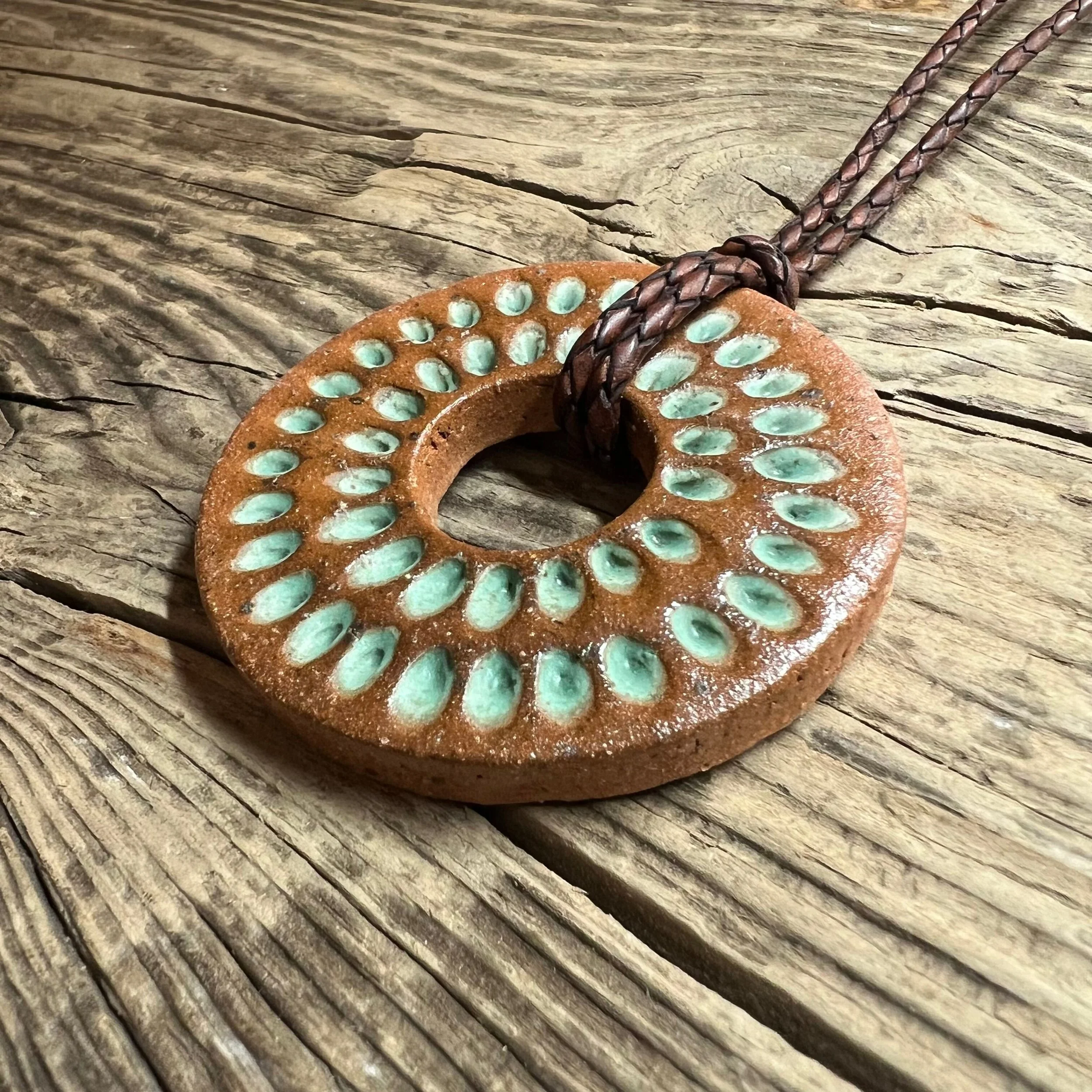 stoneware clay pendant finished in a rustic satin patina glaze inlay on leather cord