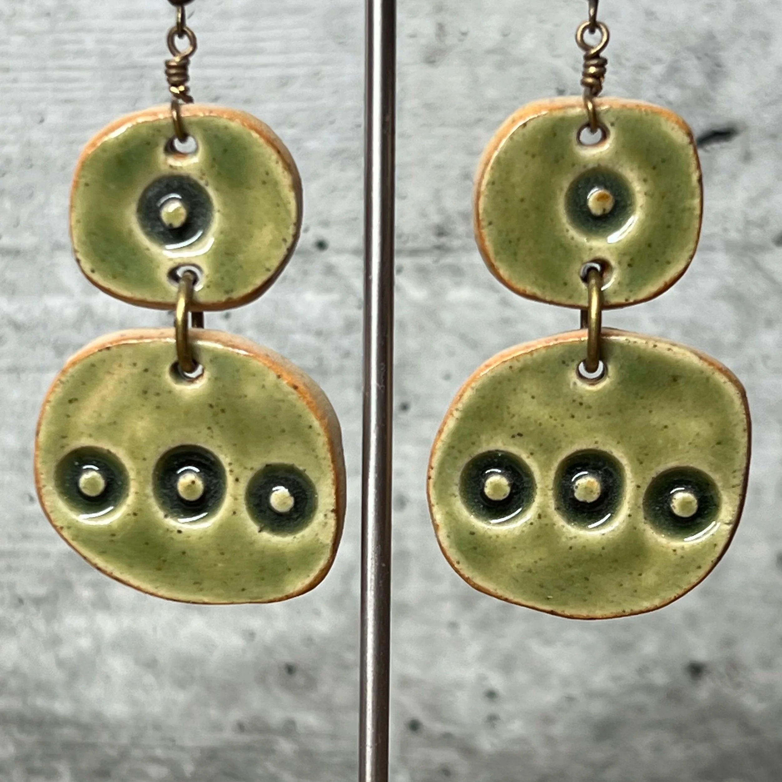 Earrings handcrafted from stoneware clay and finished with a transparent green glaze