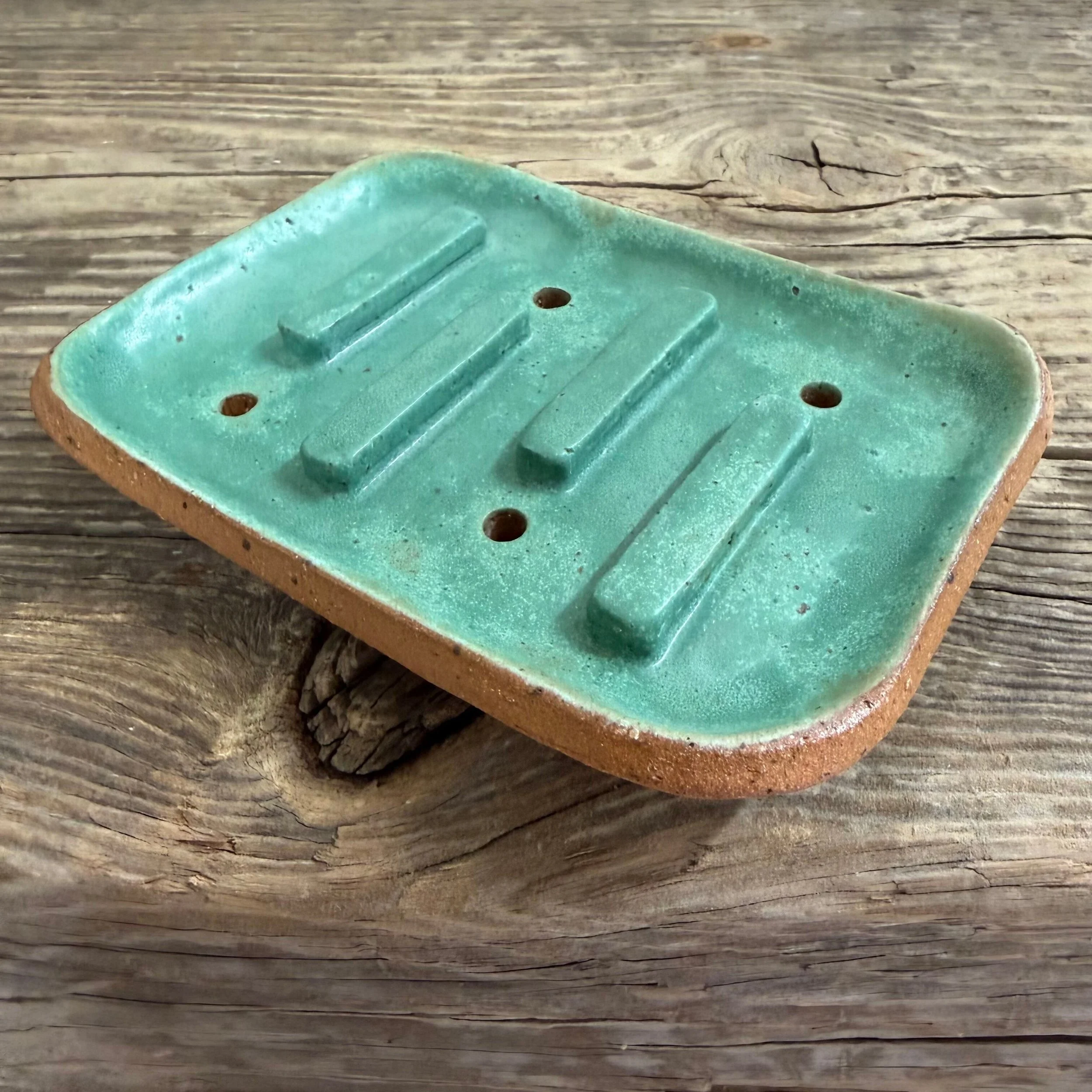 handcrafted soap dish, crafted from speckled stoneware clay and finished with a green glaze.