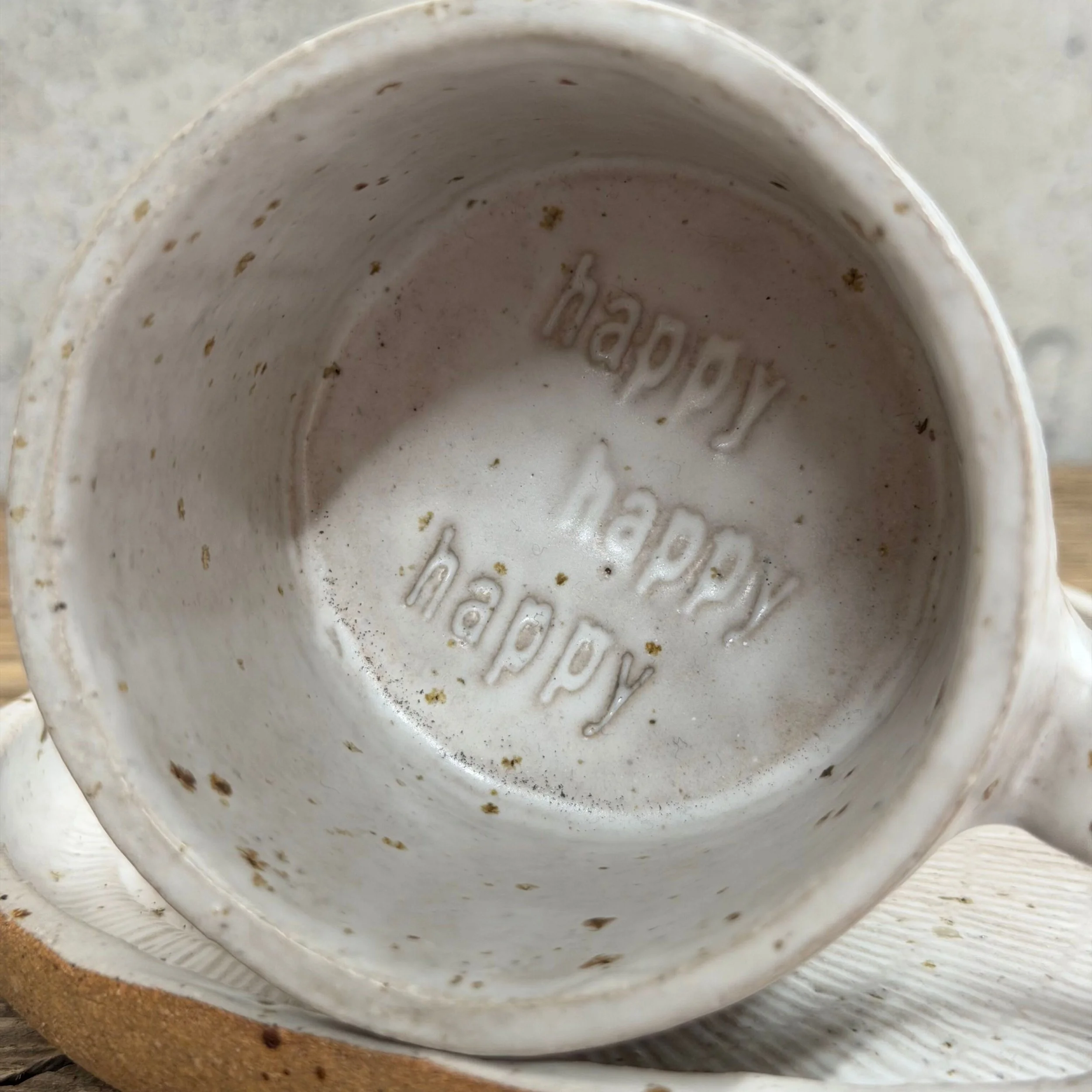 handcrafted cup and saucer, made from speckled stoneware clay and finished with a soft satin white glaze..