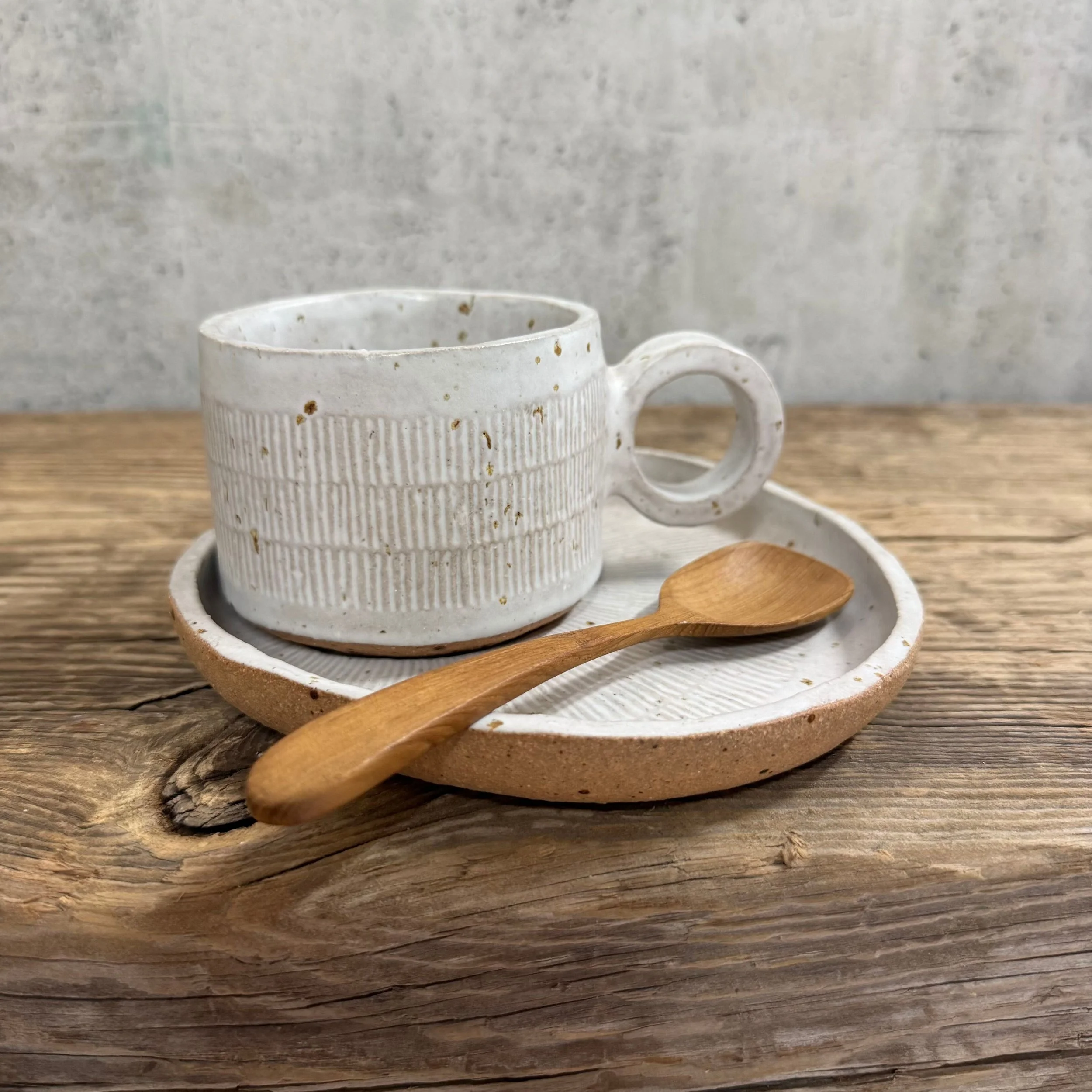 handcrafted cup and saucer, made from speckled stoneware clay and finished in a satin white glaze