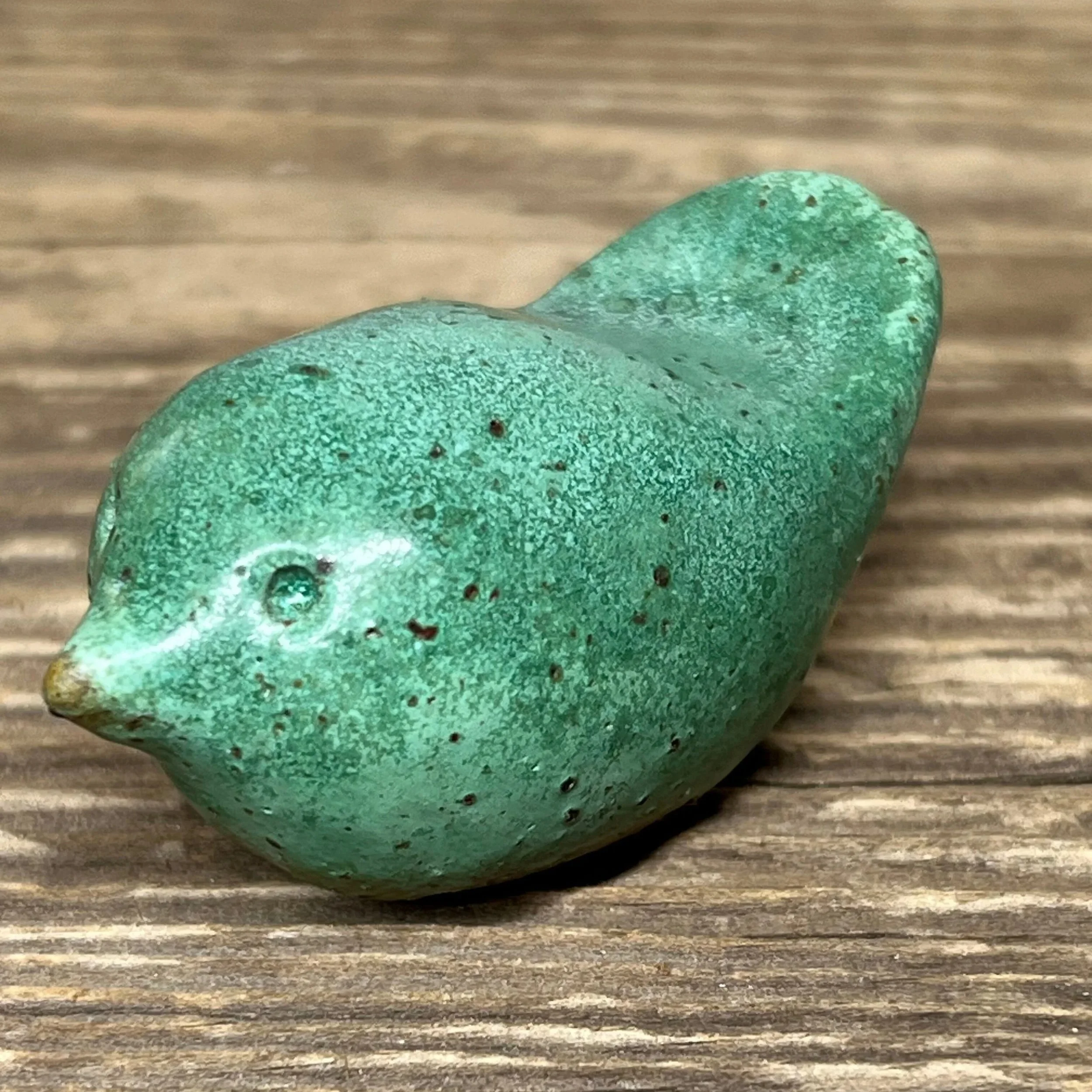 Ceramic bird handcrafted from stoneware clay and finished in a green glaze,