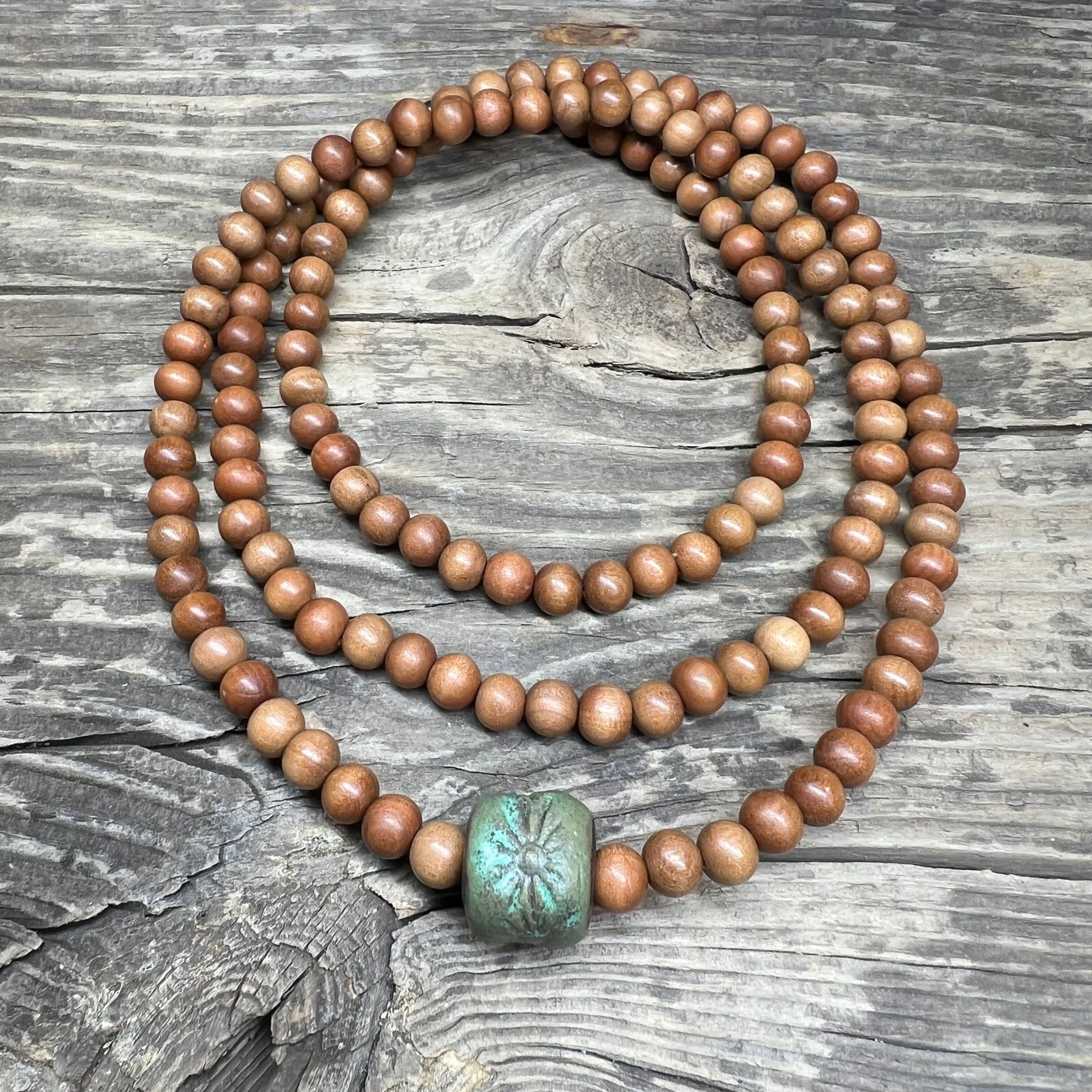 Sandalwood necklace with a handmade green ceramic bead