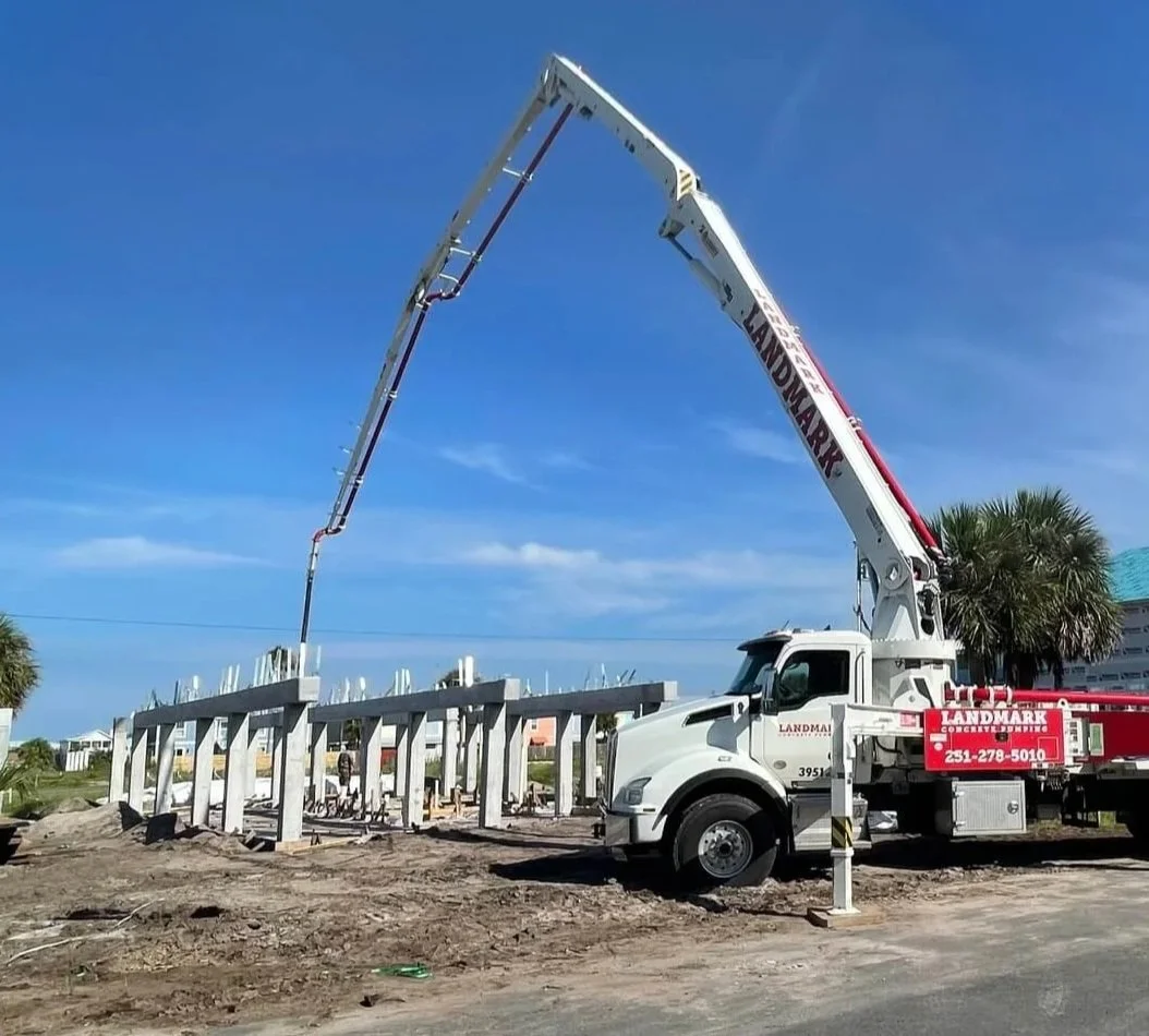 Concrete pump truck and construction site with workers