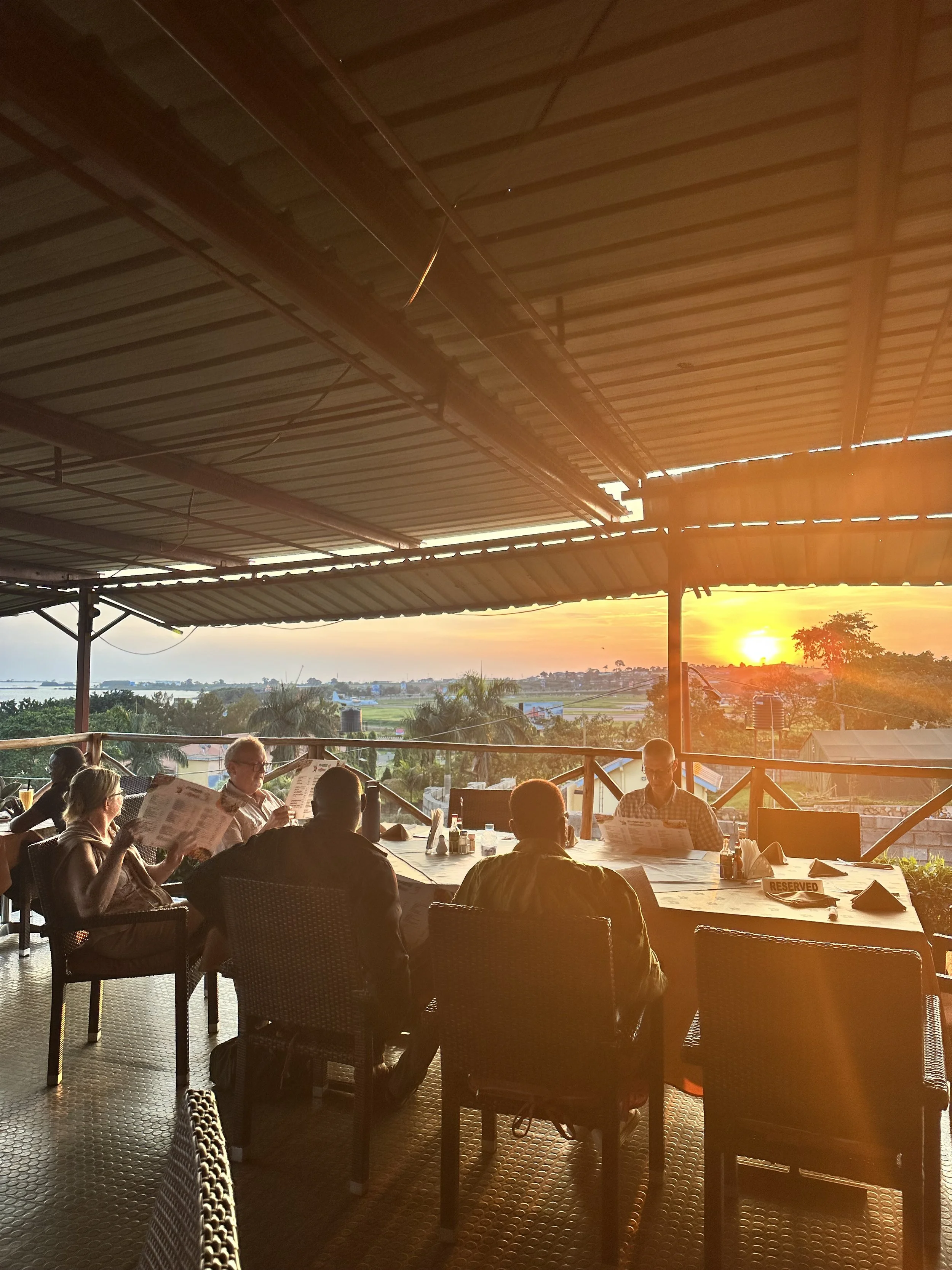Enjoying a nice dinner at sunset in Uganda on group safari experience