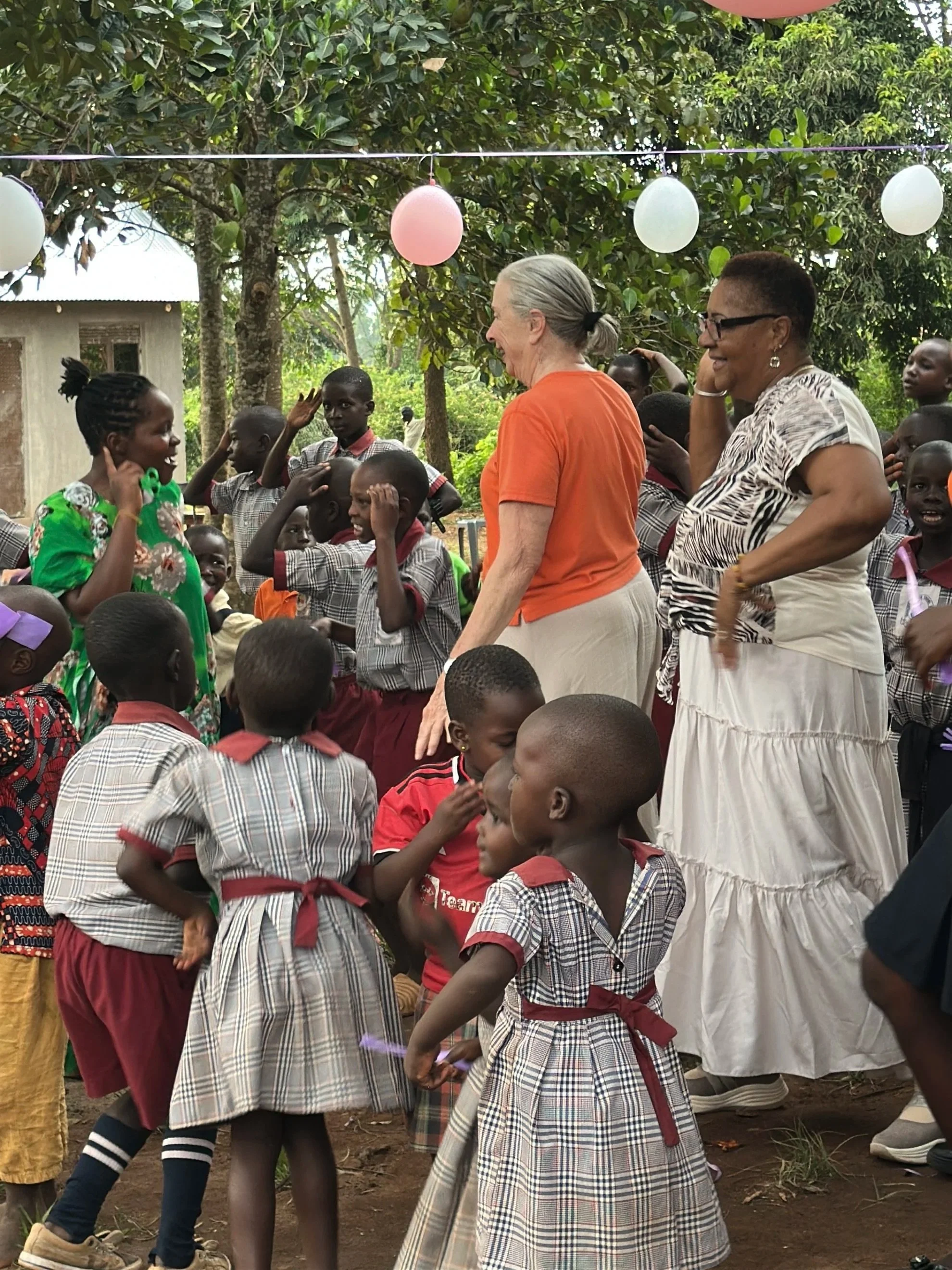 School children in Uganda dancing with guests visiting Ebenezer Junior School during Safari and Cultural Immersion in Uganda