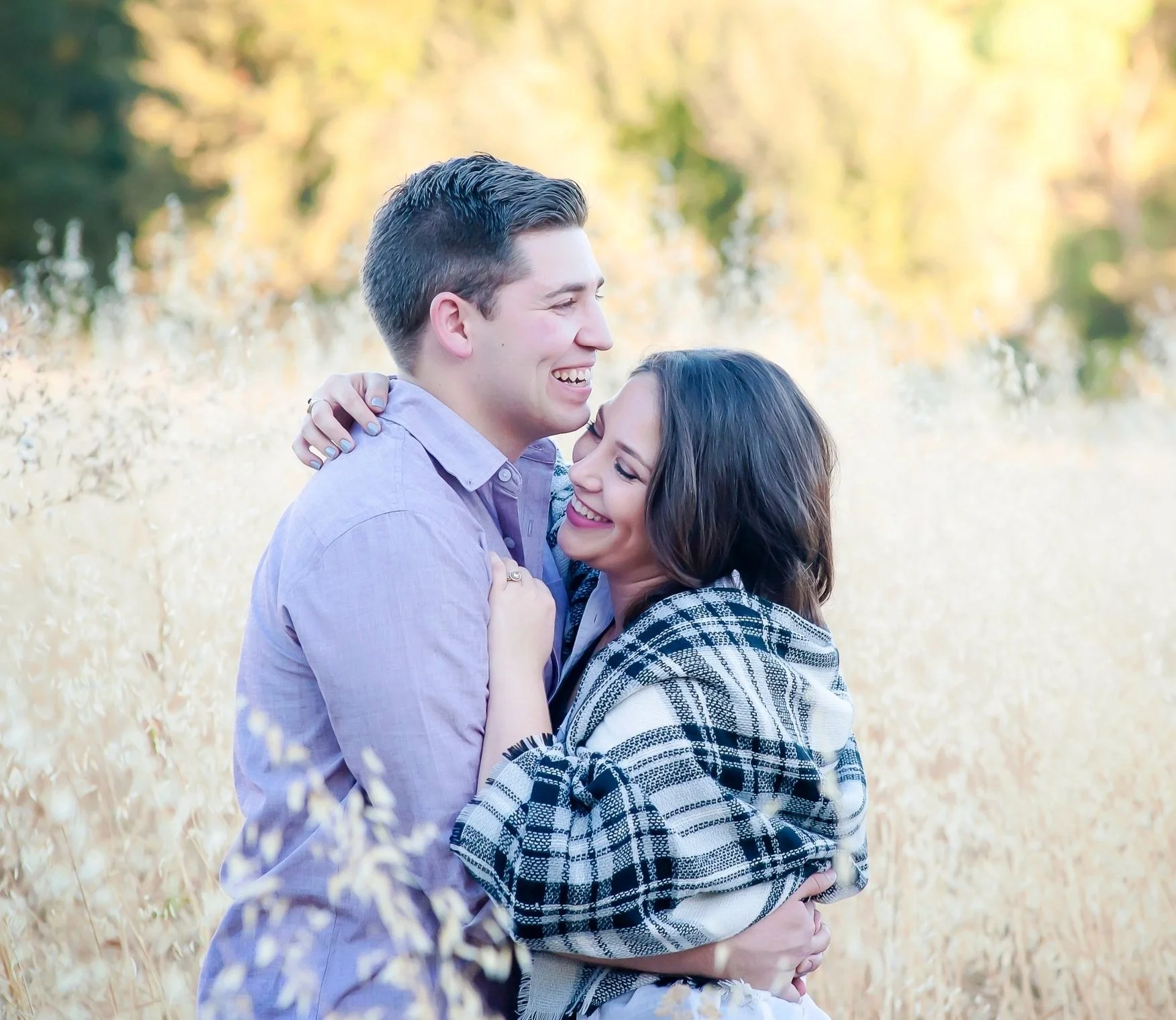 Couple laughing in a field