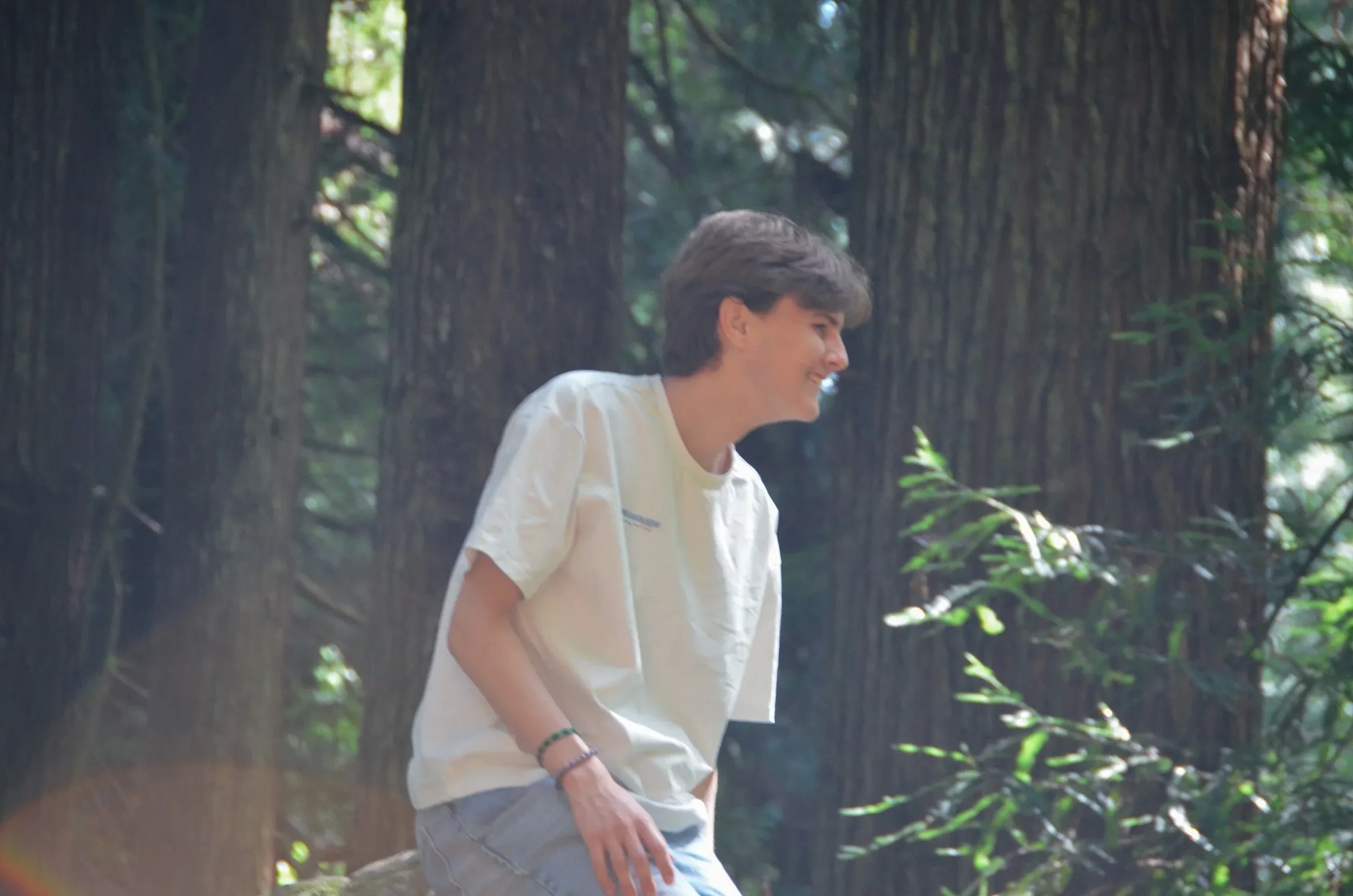 Me, Riley McDaniel, outside in the forest with a big smile.