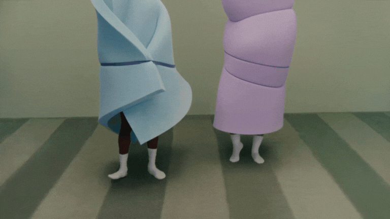 Two people are standing with their legs visible, wrapped in large, colorful, towel-like fabric structures that resemble wrapped bodies, one blue and one purple.