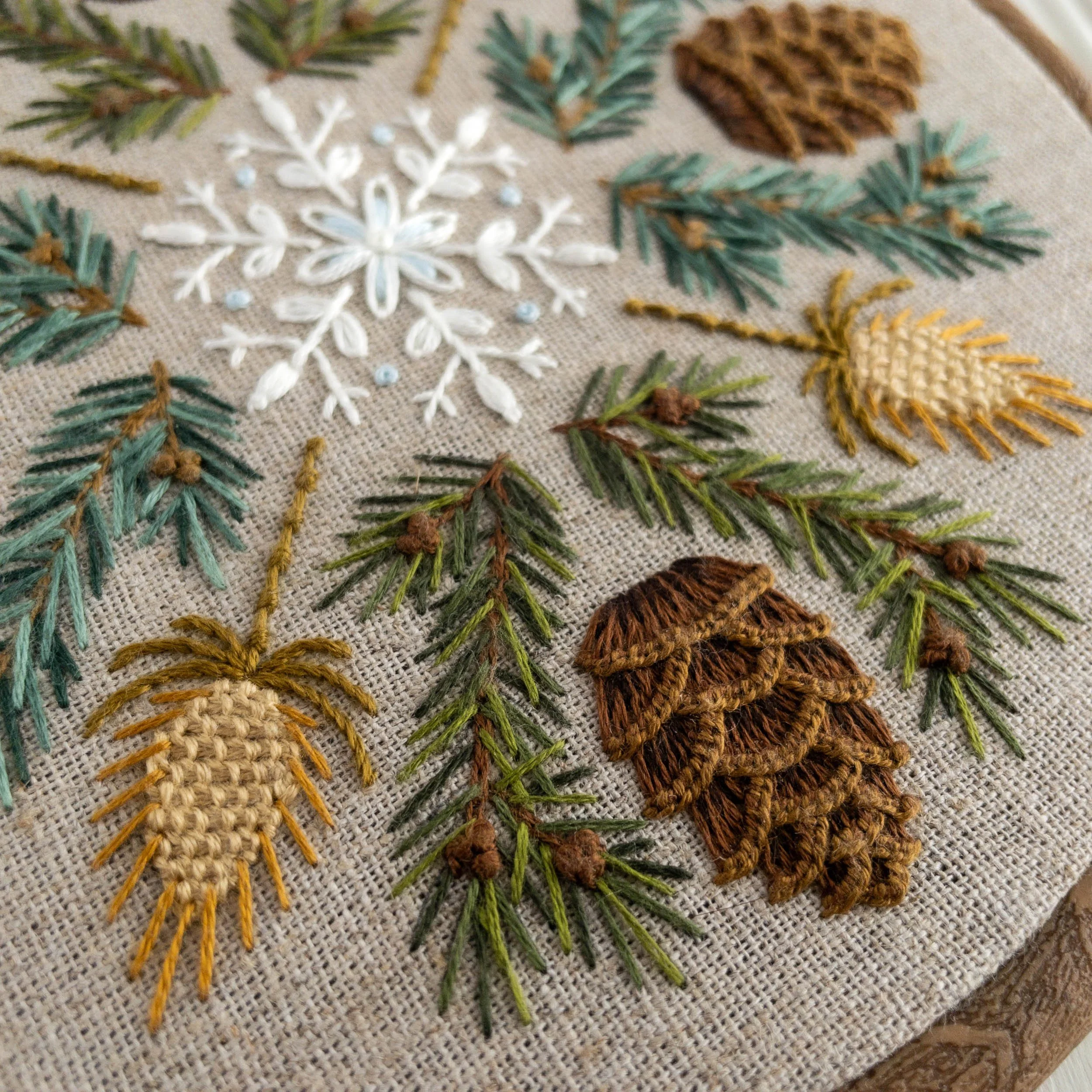 Winter sampler, hand embroidery with pine cones