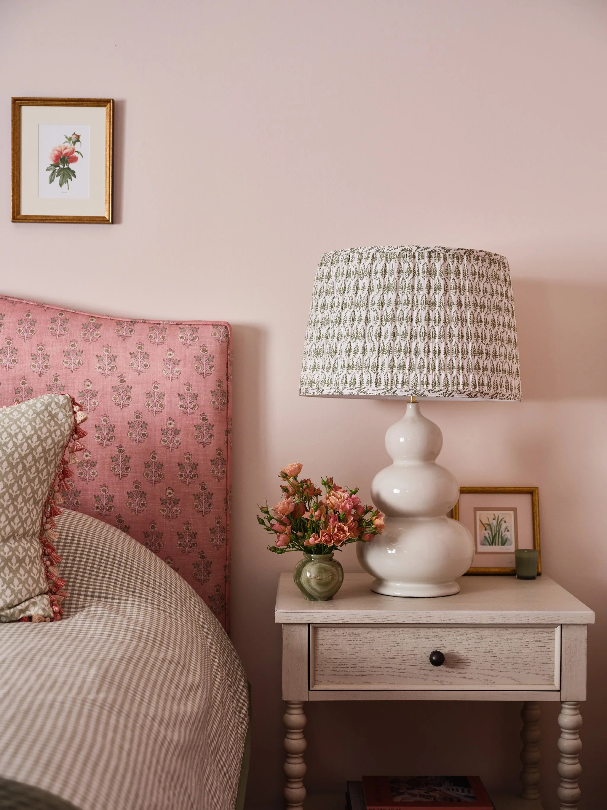 Pink bedroom in Kentfield by Arntz Interiors featuring a floral upholstered headboard, patterned textiles, and soft romantic details.