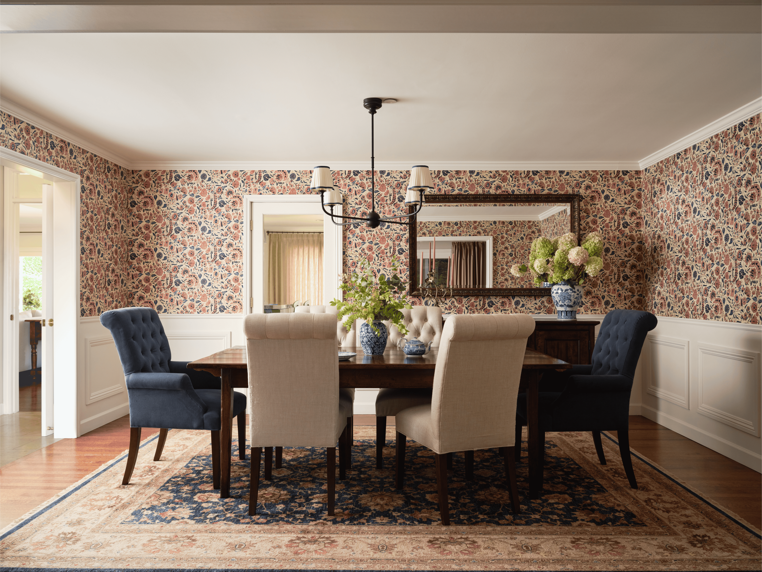 Kentfield dining room by Arntz Interiors with traditional floral wallpaper, upholstered dining chairs, and layered English-inspired details.