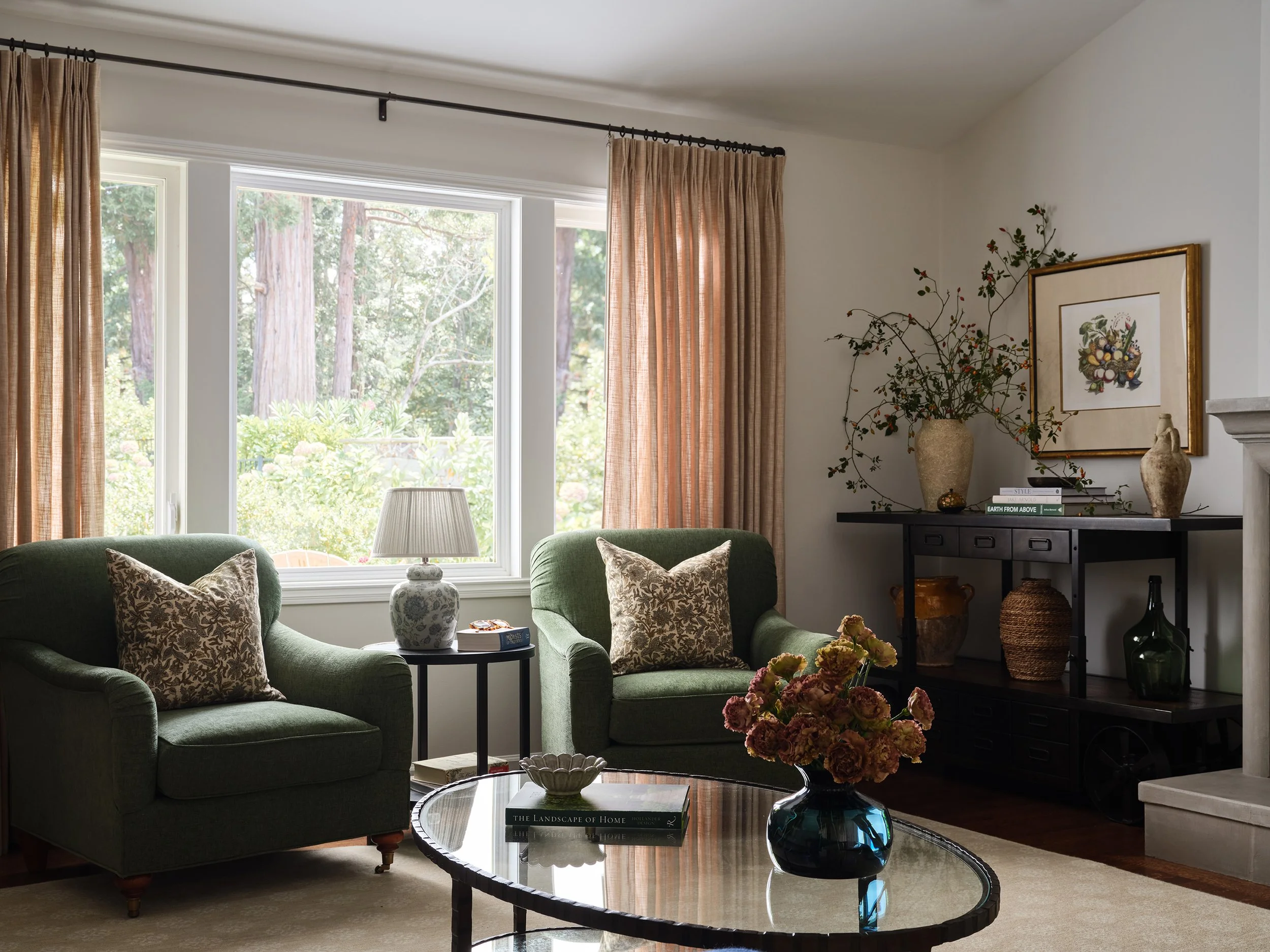 Cozy Kentfield living room designed by Arntz Interiors featuring green armchairs, botanical accents, and warm natural textures.
