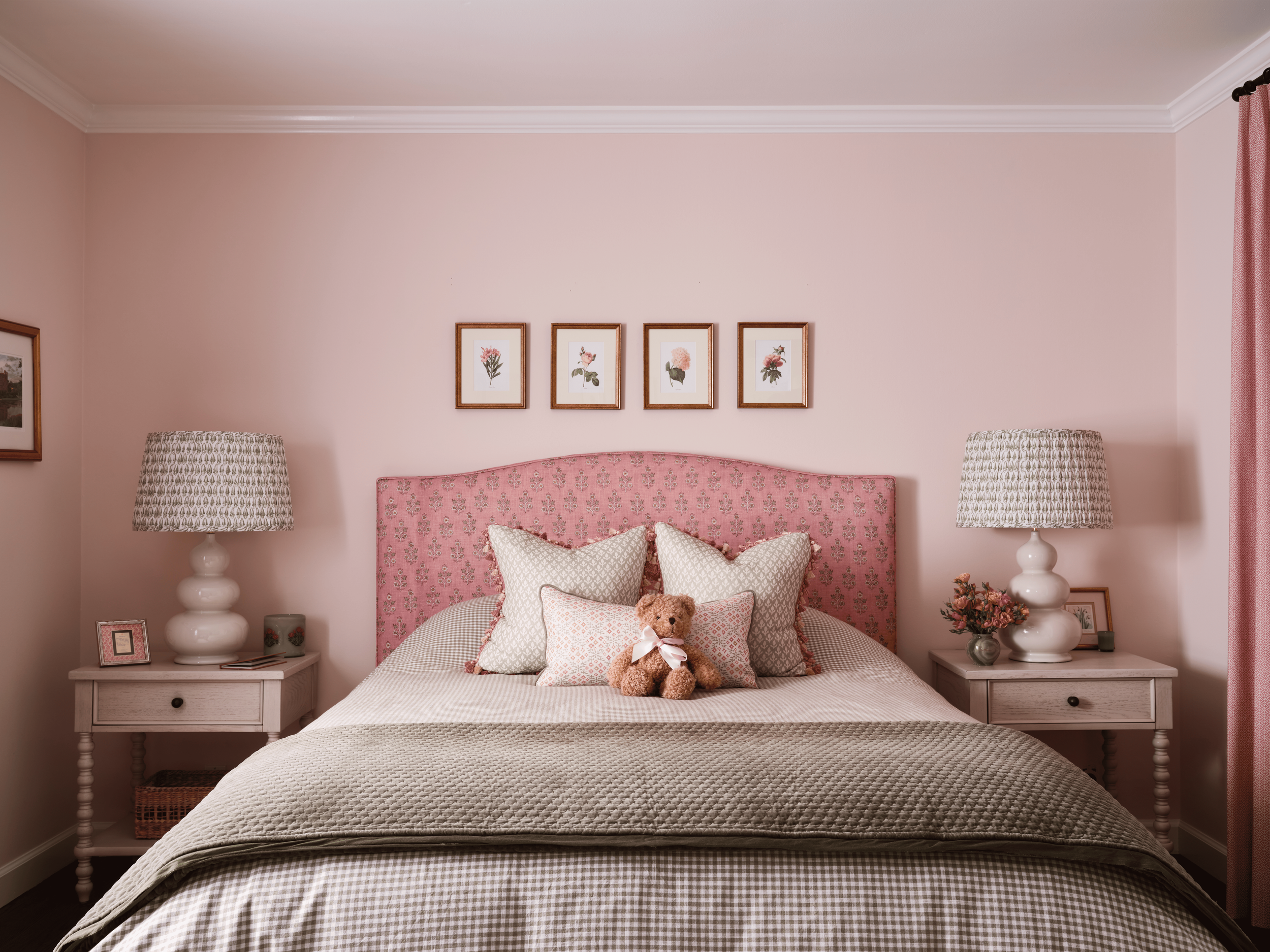 Floral bedroom in Kentfield designed by Arntz Interiors featuring a pink upholstered headboard, layered textiles, and soft neutral tones.