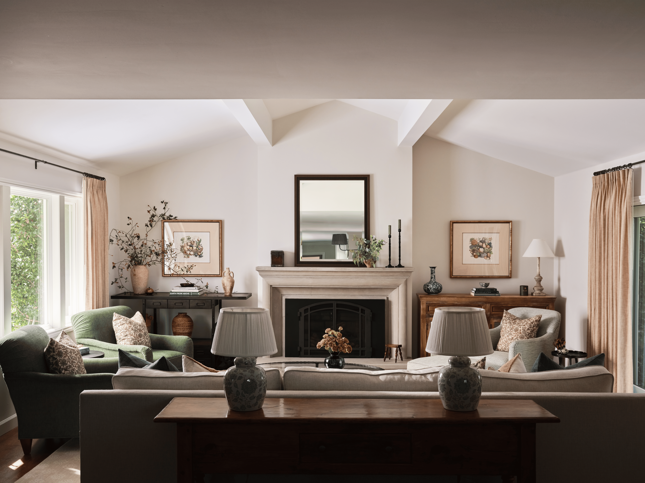 Kentfield family room by Arntz Interiors with a stone fireplace, layered seating, classic artwork, and soft neutral furnishings.