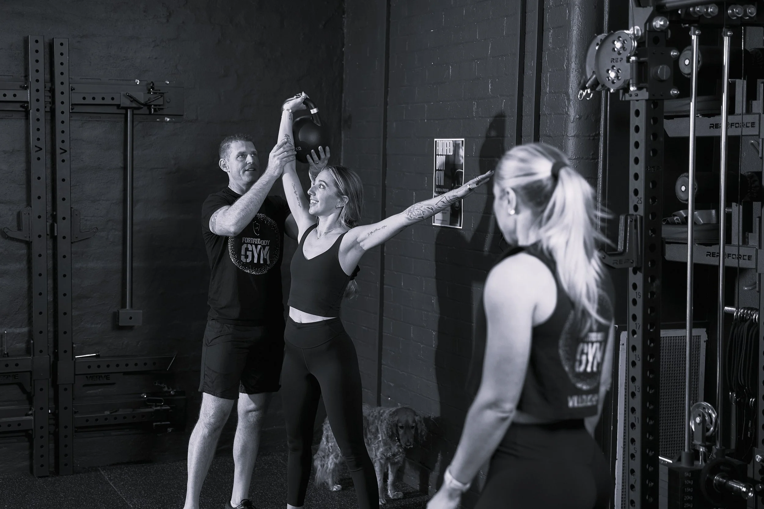 coach instructing kettlebell movements in personal training session