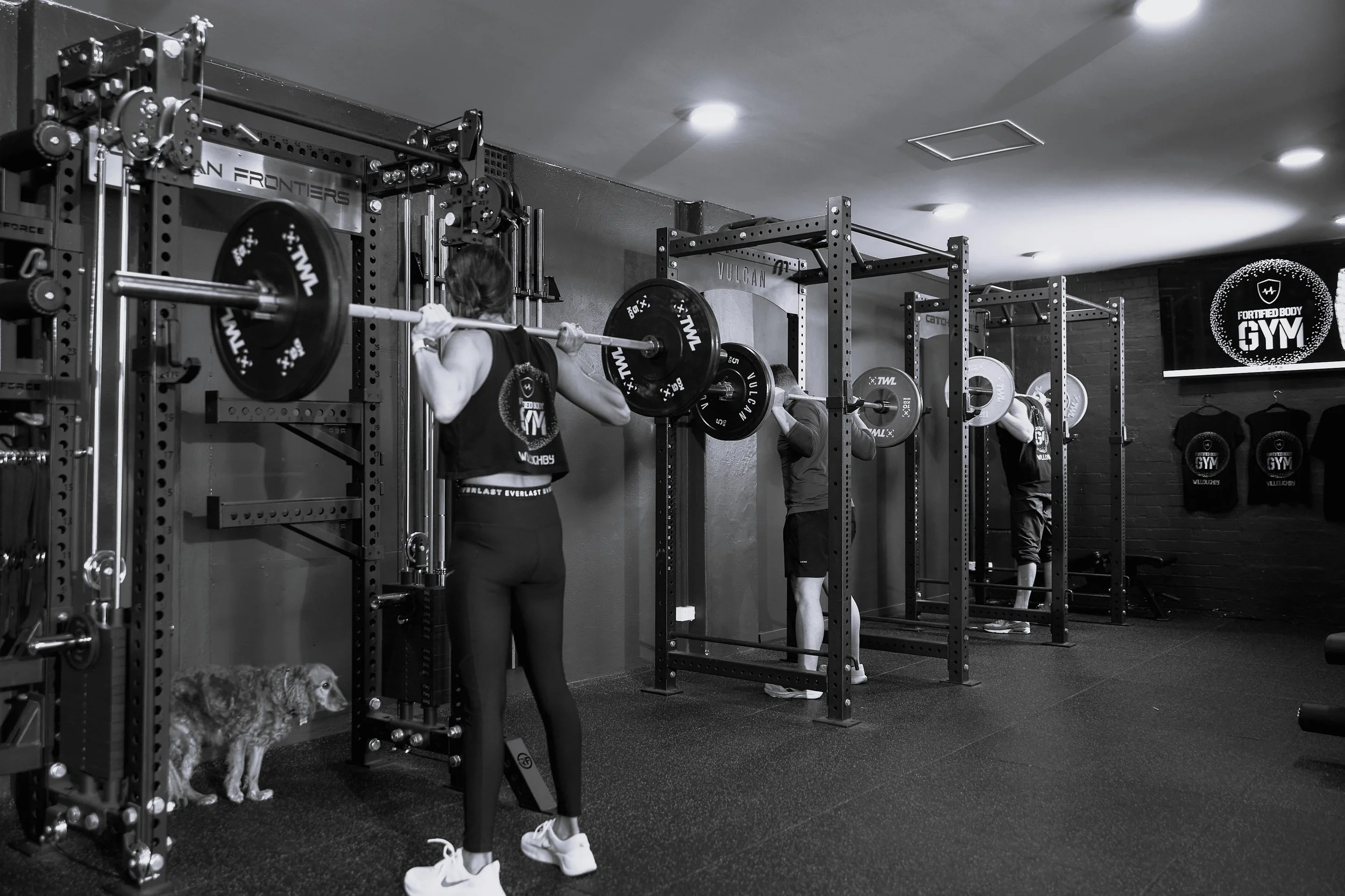 Three Willoughby gym members squatting