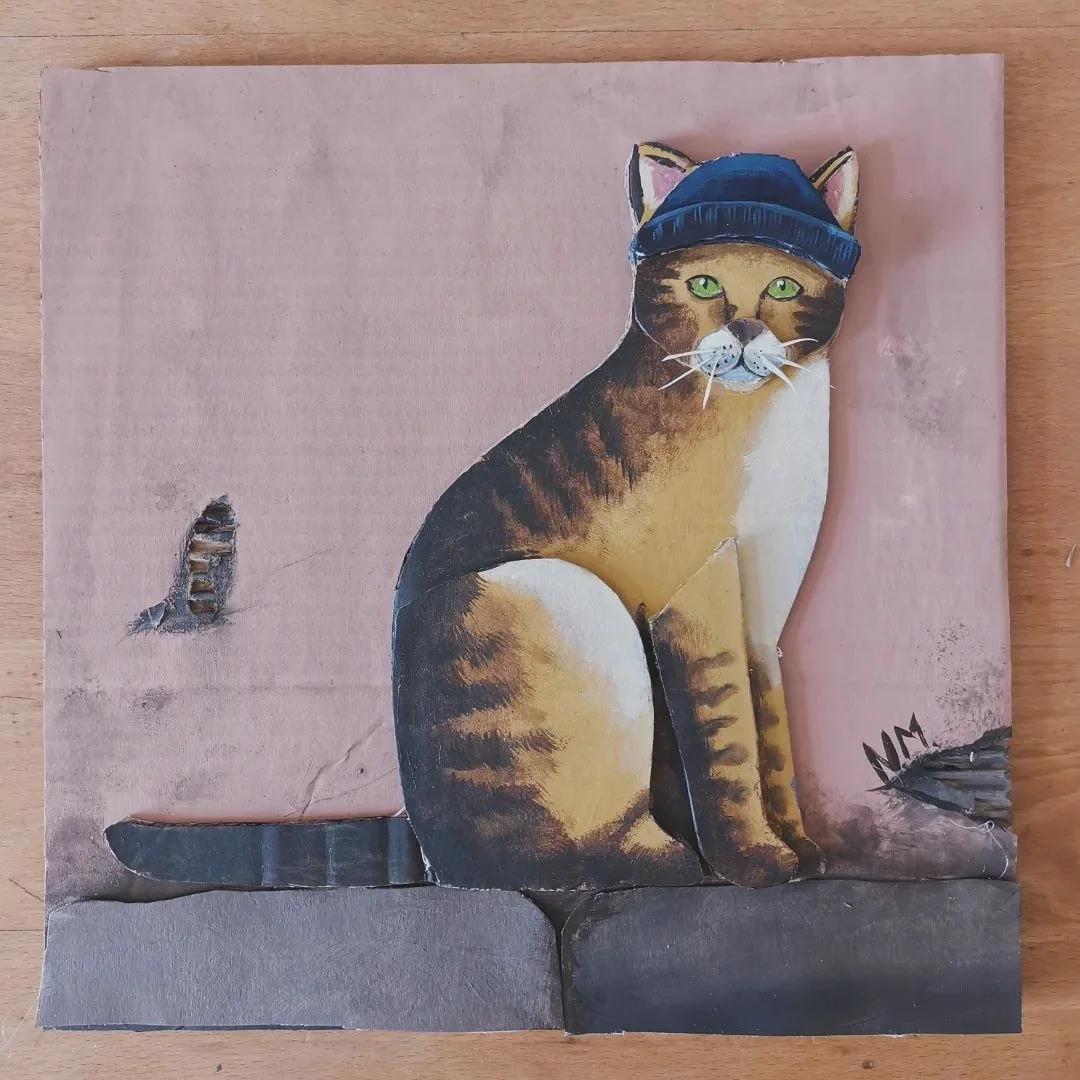 Die Katze mit der blauen Mütze