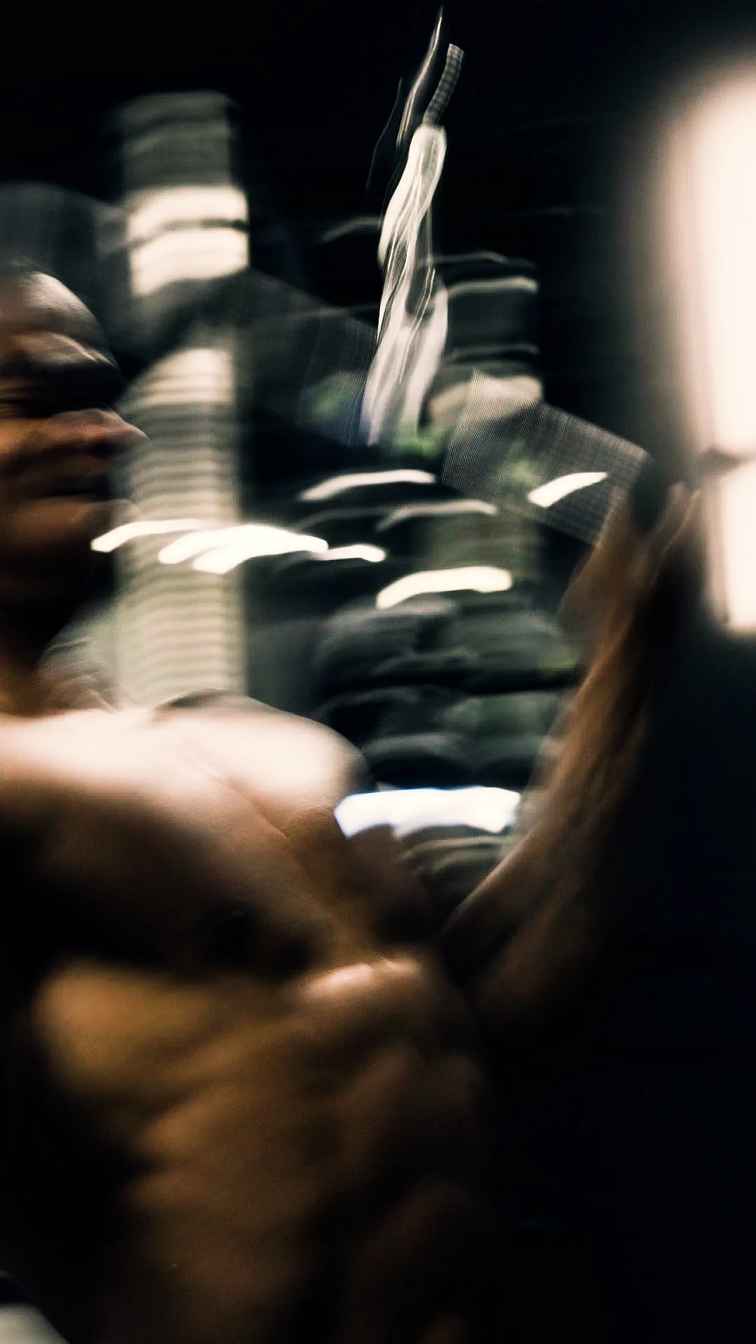 Blurred image of a person holding a smartphone, with streaks of light and streaks of motion indicating movement.