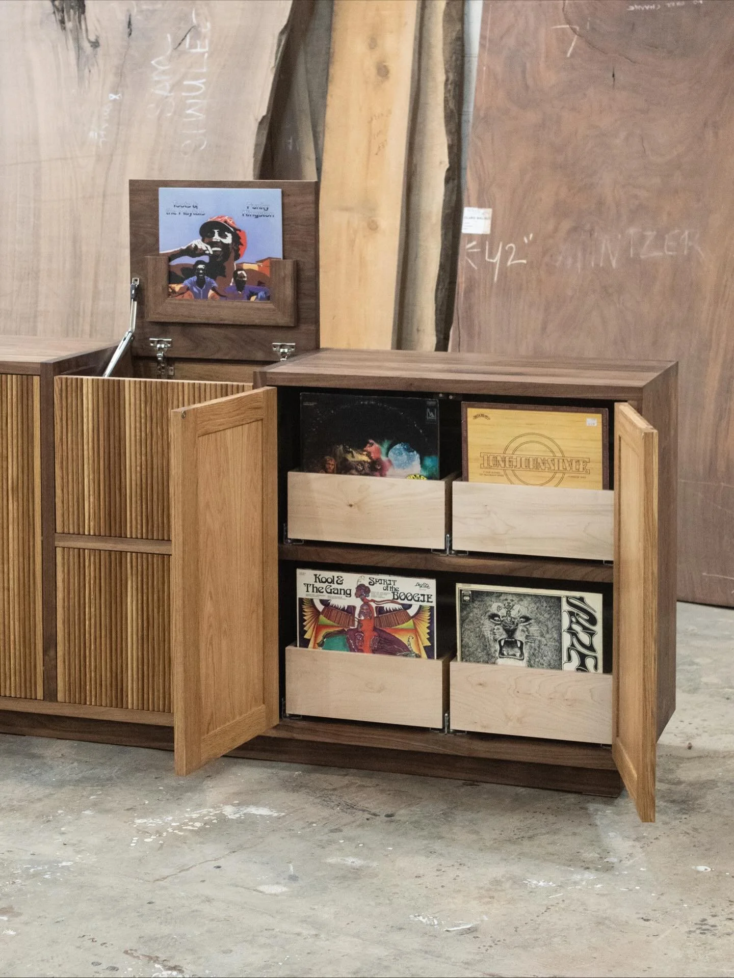 Custom walnut and white oak record unit. // this was custom made and designed to fit the clients turntable, receiver and woofer. // we also wanted to provided that same record store experience at home. I personally love flipping through record crates