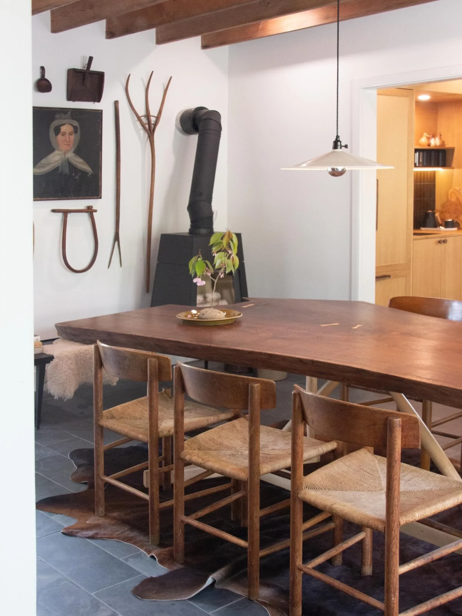 Every now and then we make visits to clients homes long after the pieces have been delivered to see how they are being used and styled. This is a stunning example of that. // custom commissioned live edge table (and work table /island in the backgrou