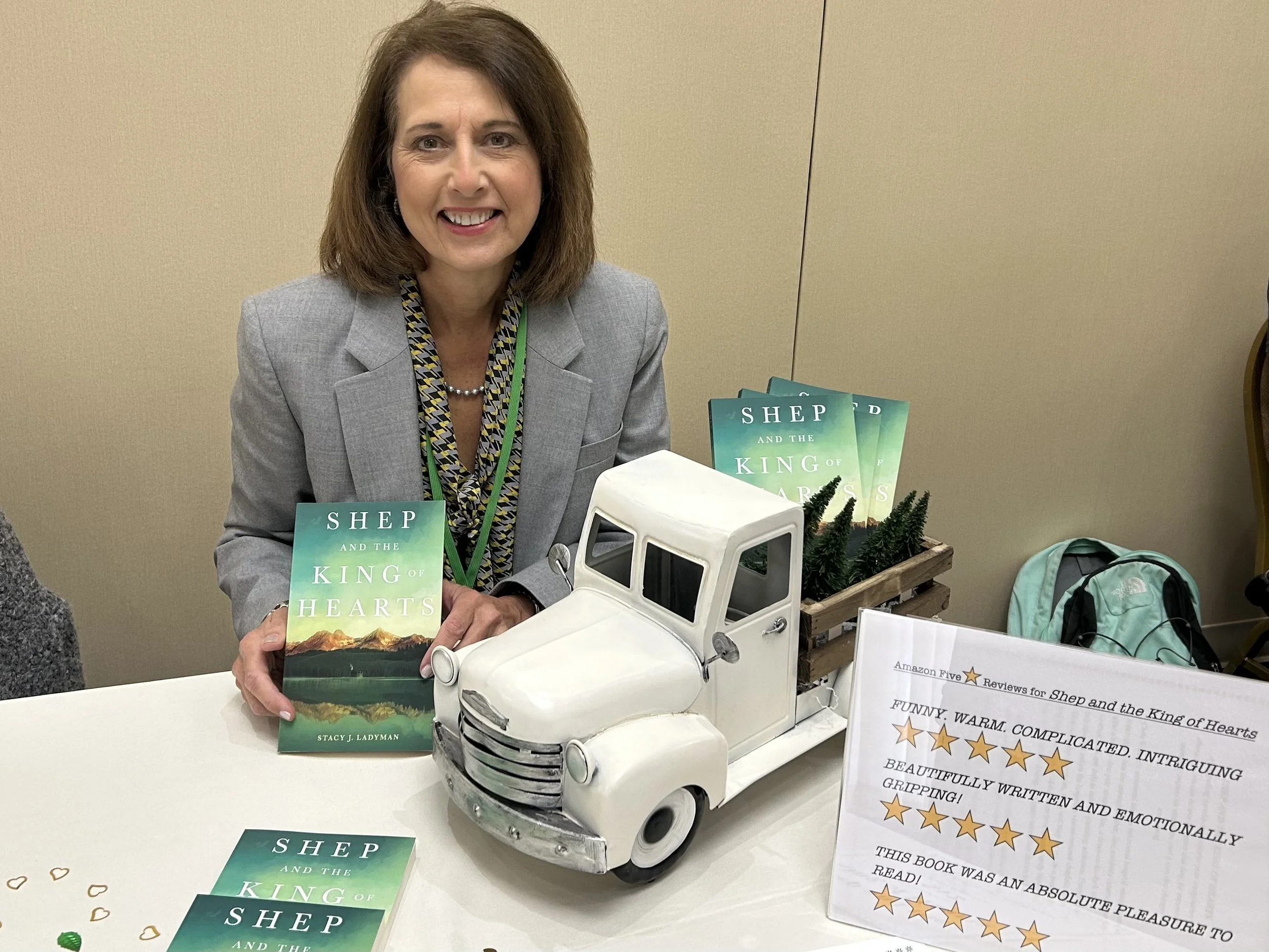 Stacy J. Ladyman holding her five star reviewed book Shep and the King of Hearts