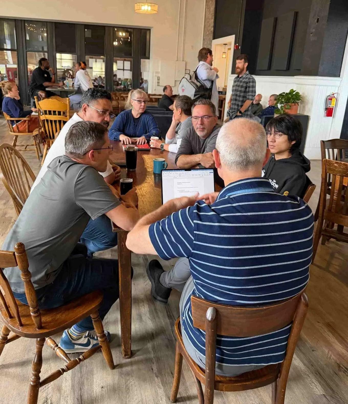 Leaders gathered around tables for a small-group discussion during an ALL CHANGE workshop